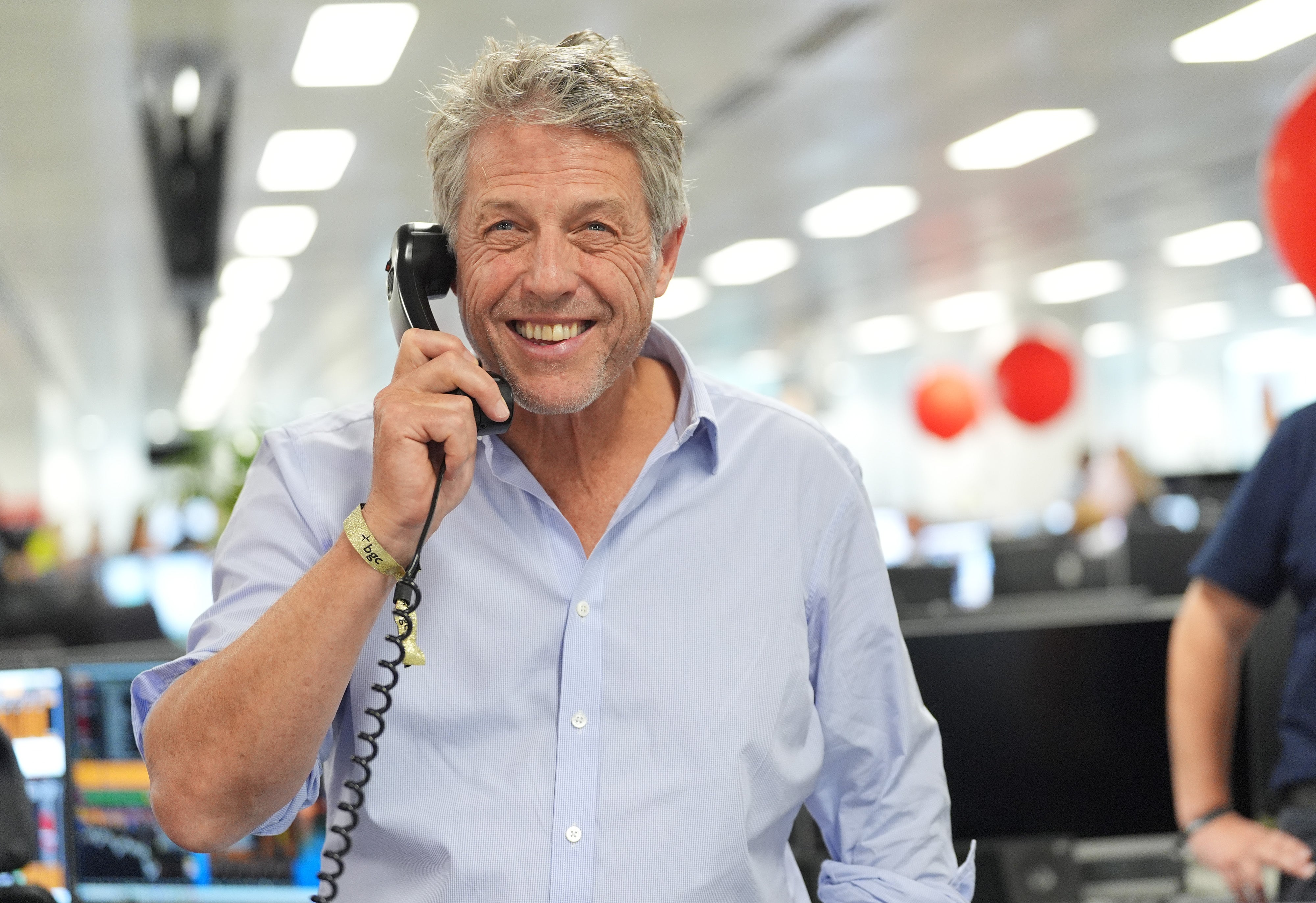Hugh Grant on the trading floor (PA)