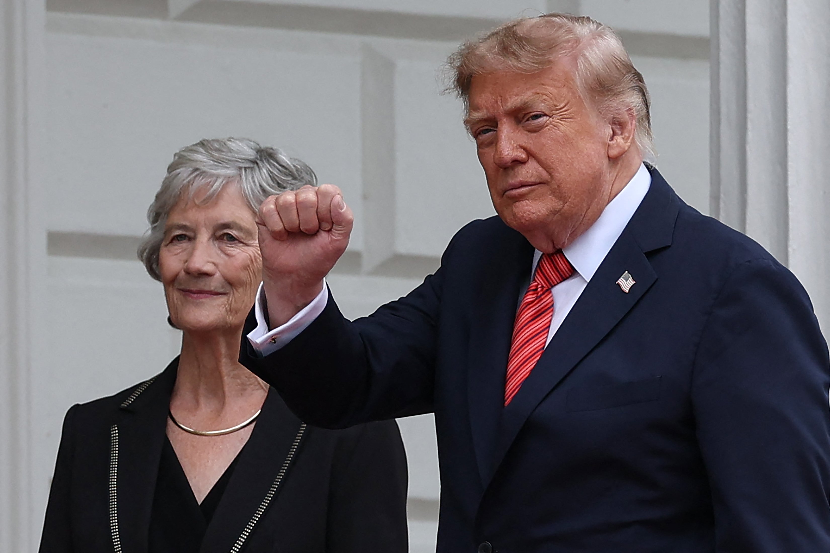 US President Donald Trump (R) gestures as he is welcomed by Ireland's President Catherine Connolly (L) at Áras an Uachtaráin in Phoenix Park in the Irish capital Dublin