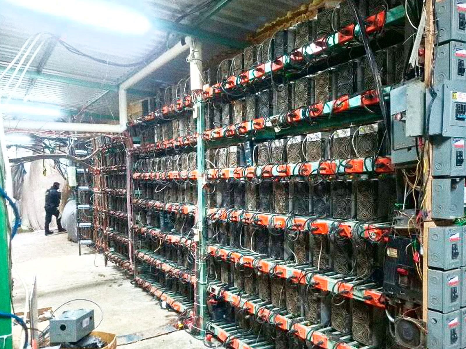 A police officer at a property seized by authorities that was allegedly used to house and operate specialized cryptocurrency mining equipment during an operation in Tlaola, Mexico, in this handout image distributed on September 6, 2026