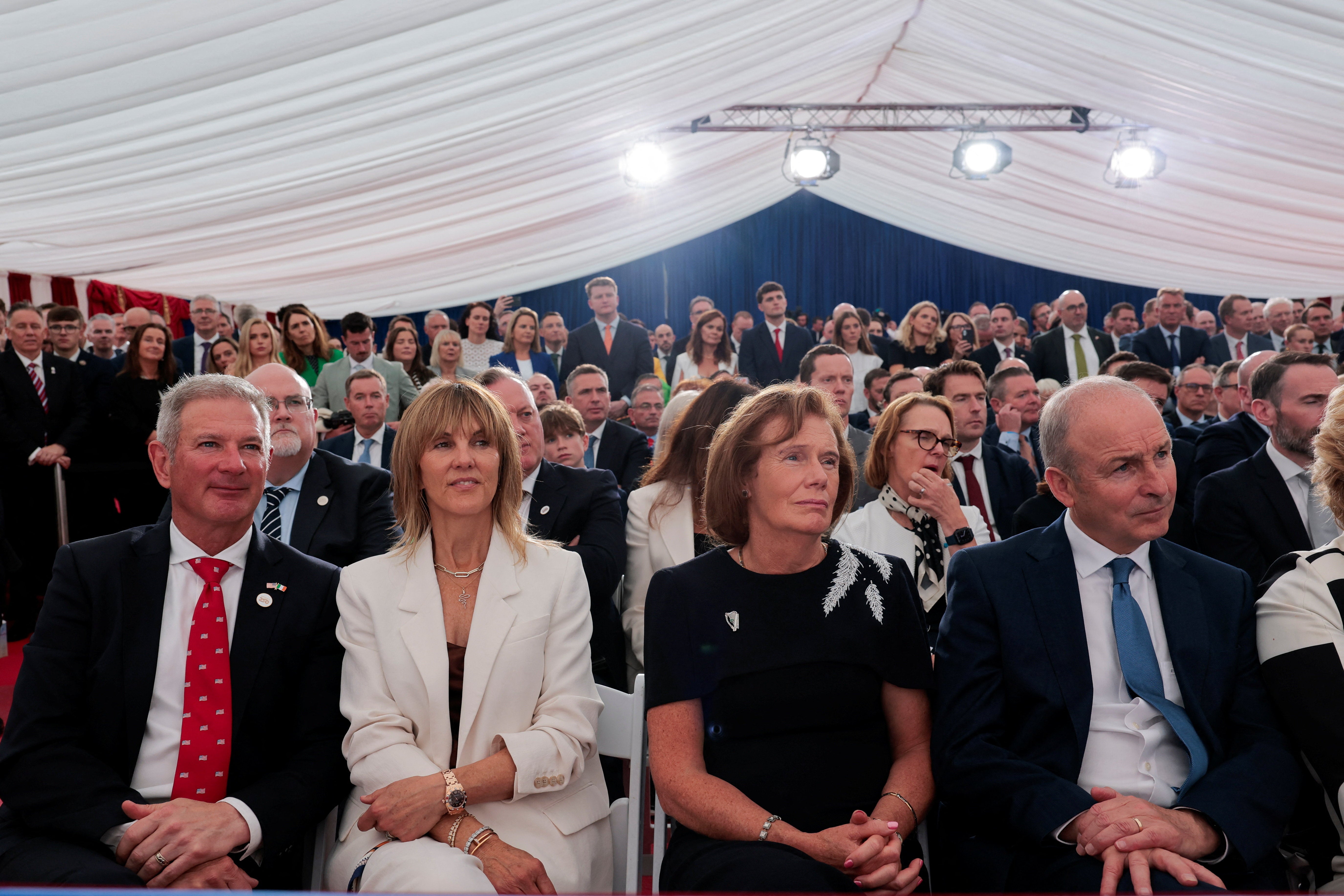 Ireland's prime minister (Taoiseach) Micheal Martin, his wife Mary O’Shea, US ambassador to Ireland Edward Walsh and his wife Lynn Walsh listen to Mr Trump