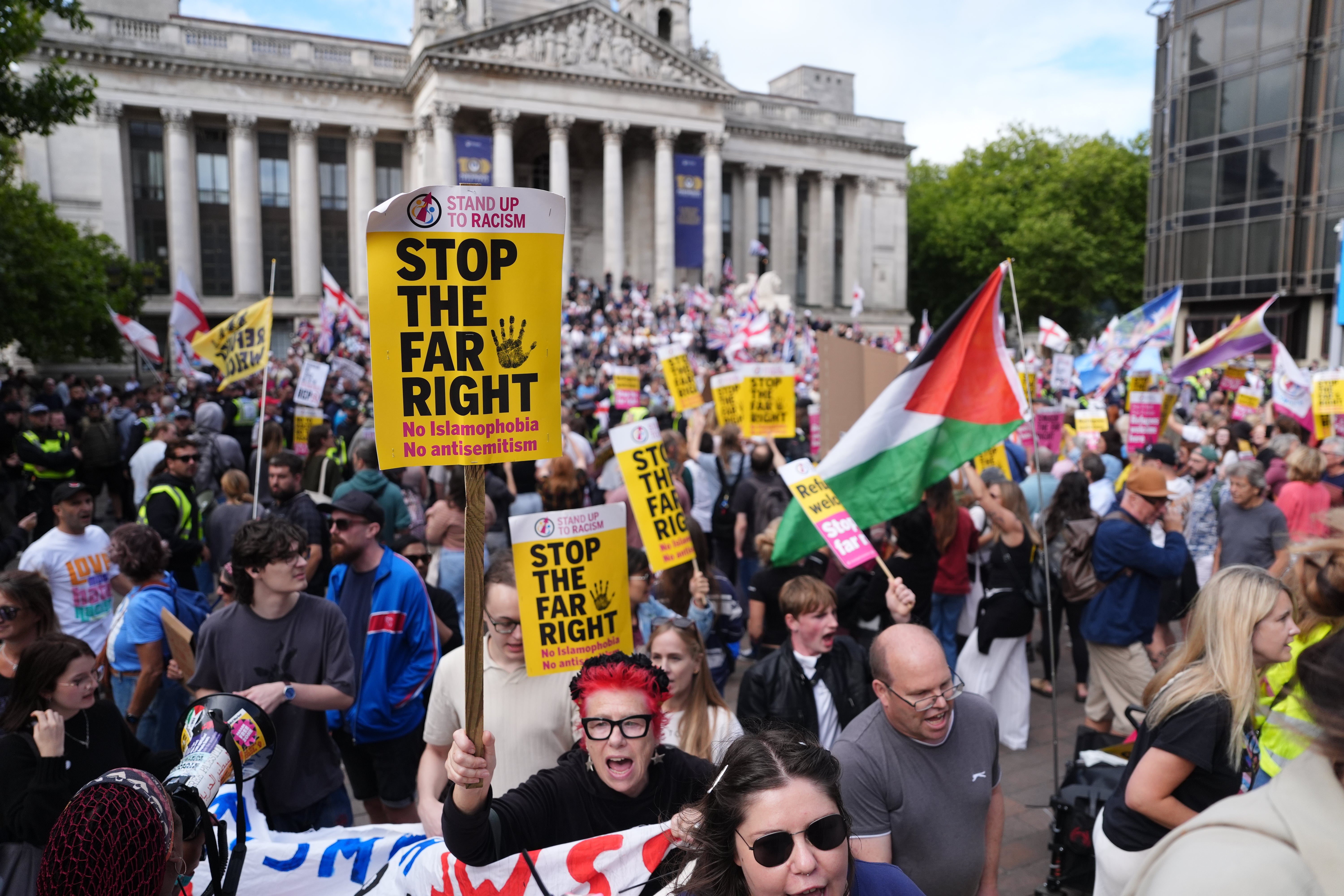 Counter protesters held signs in support of the RNLI (Jonathan Brady/PA)