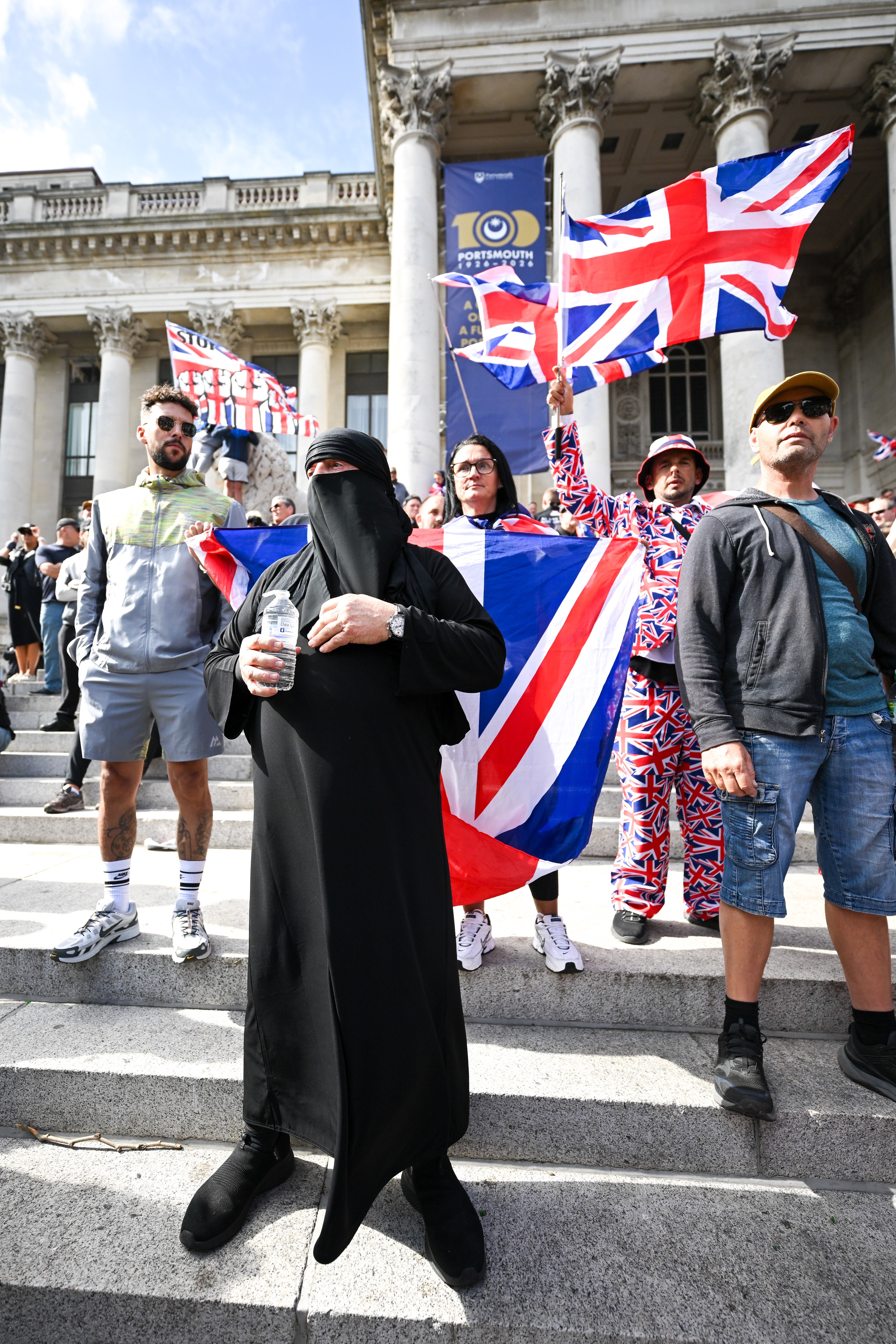 An anti-migrant protester wears a burkha during a march through the city to Guildhall in Portsmouth