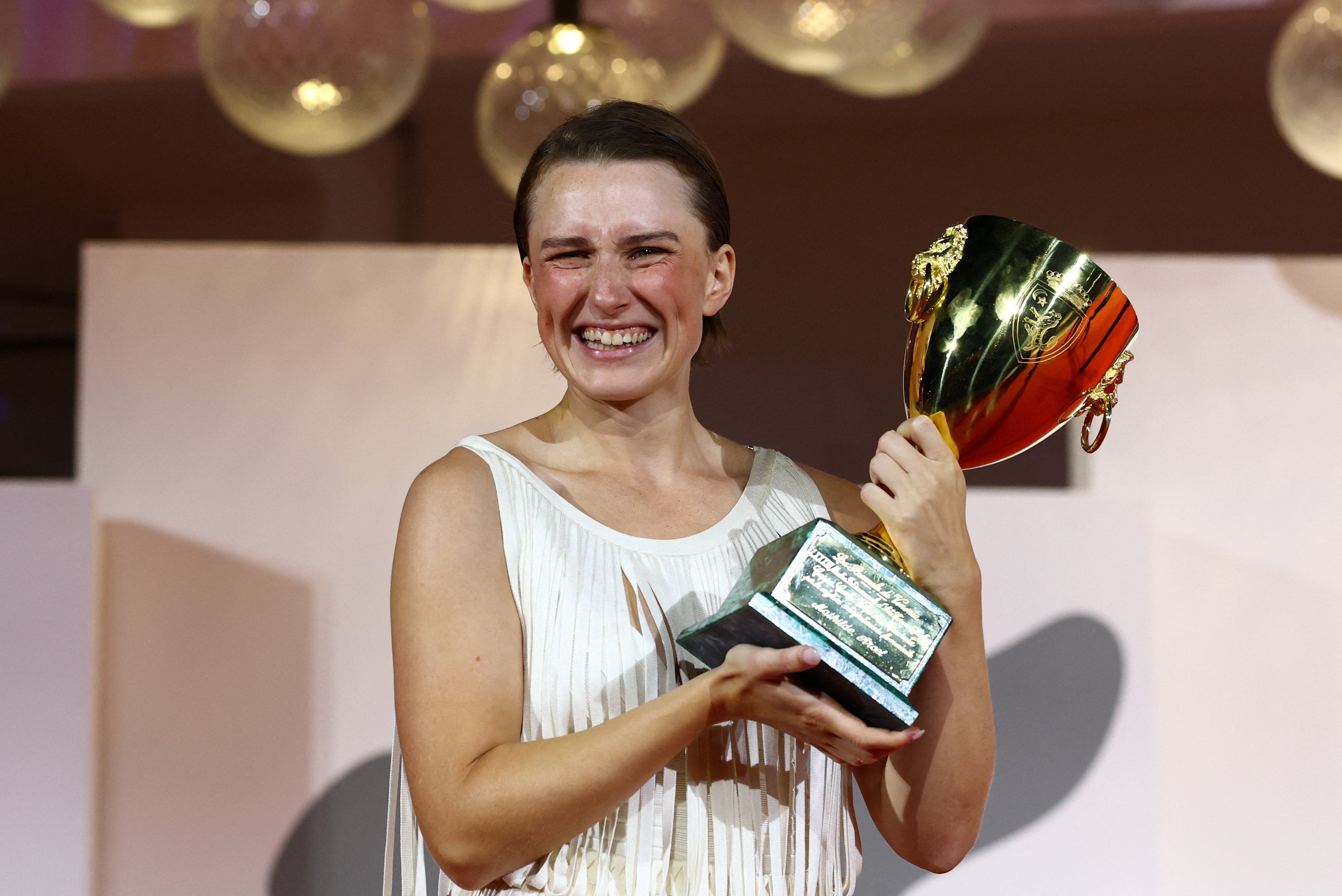 Mathilde Arcel poses with the Coppa Volpi Award for Best Actress