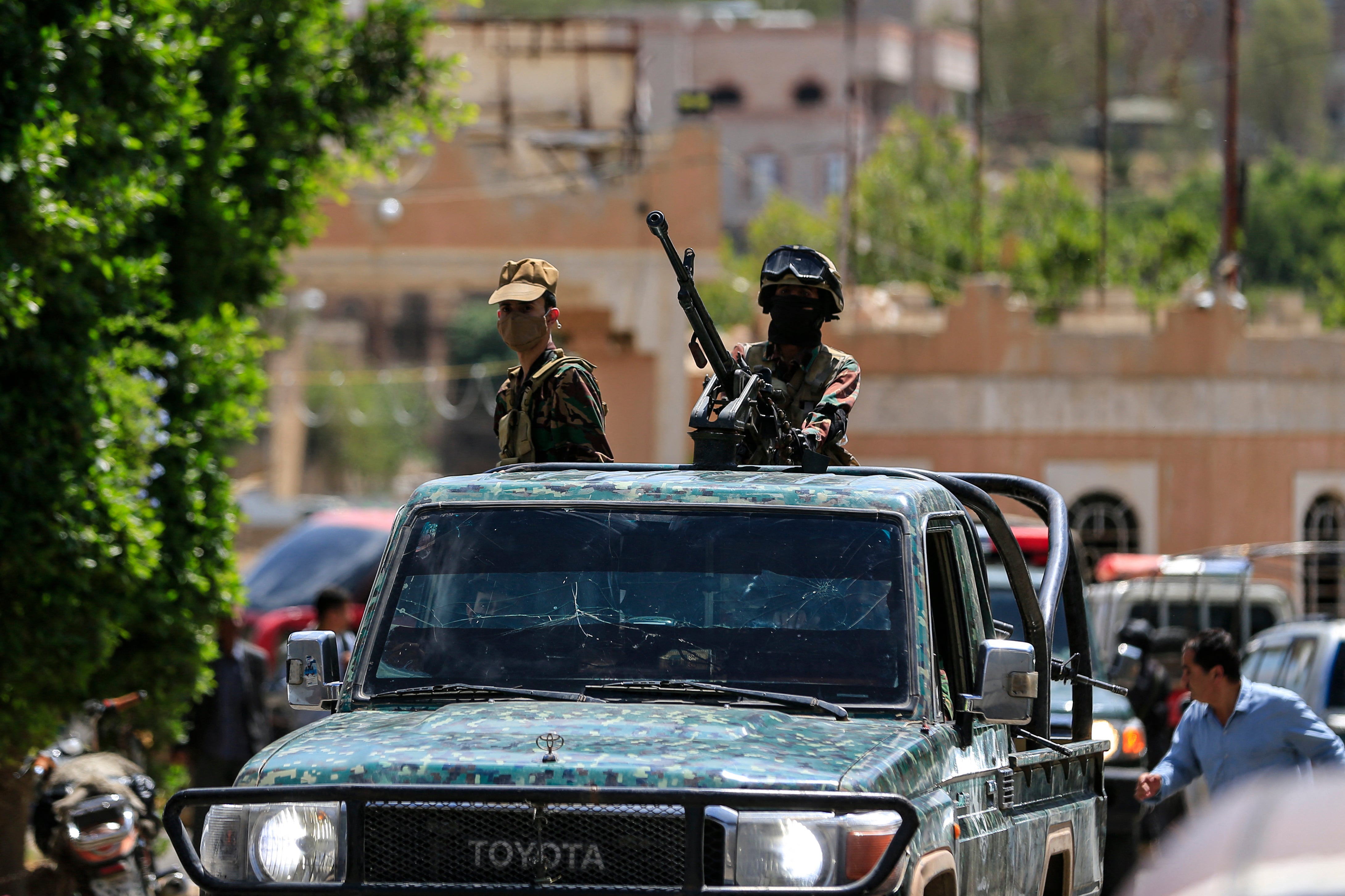 Yemen's Houthi armed forces patrol as Yemeni prisoners loyal to the Houthi authorities arrive in the capital Sanaa on 12 September 2026