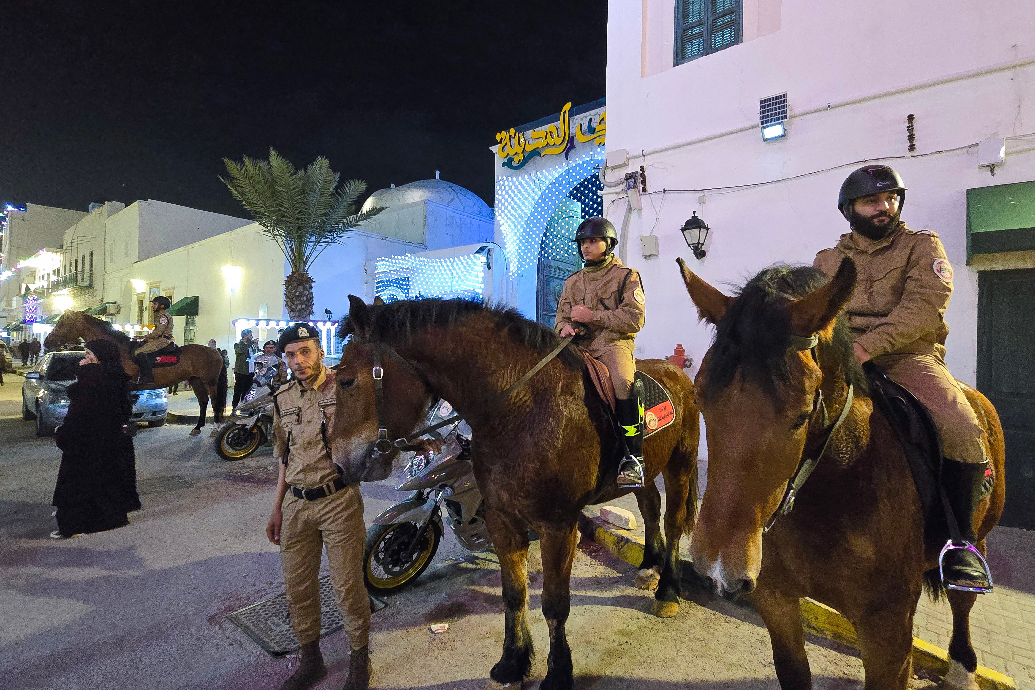 Horse-mounted policemen guard a market area in Tripoli early on March 11, 2025