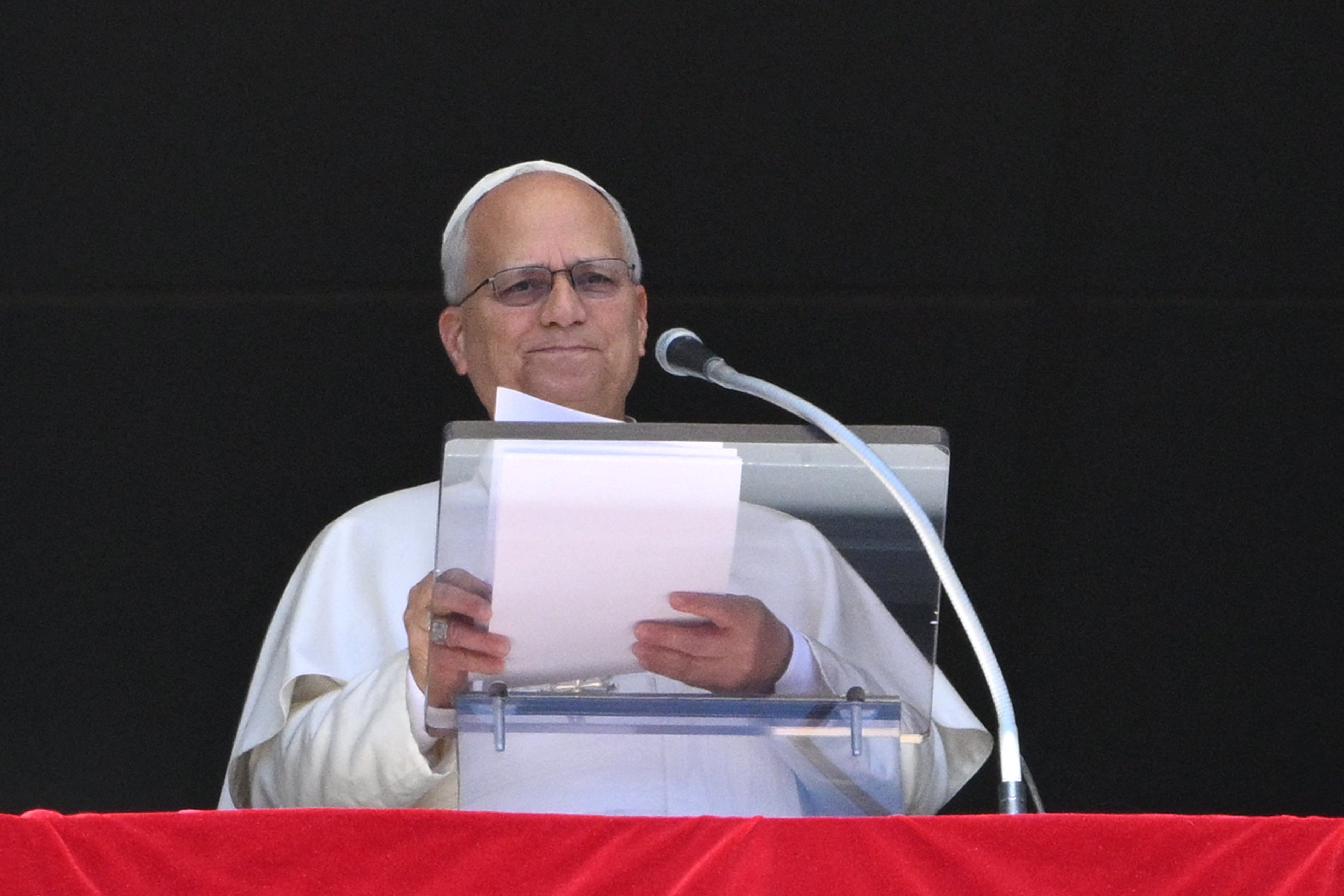 Pope Leo XIV addresses the crowd from the window of the apostolic palace overlooking St Peter's Square during his Sunday Angelus prayer at the Vatican on September 13