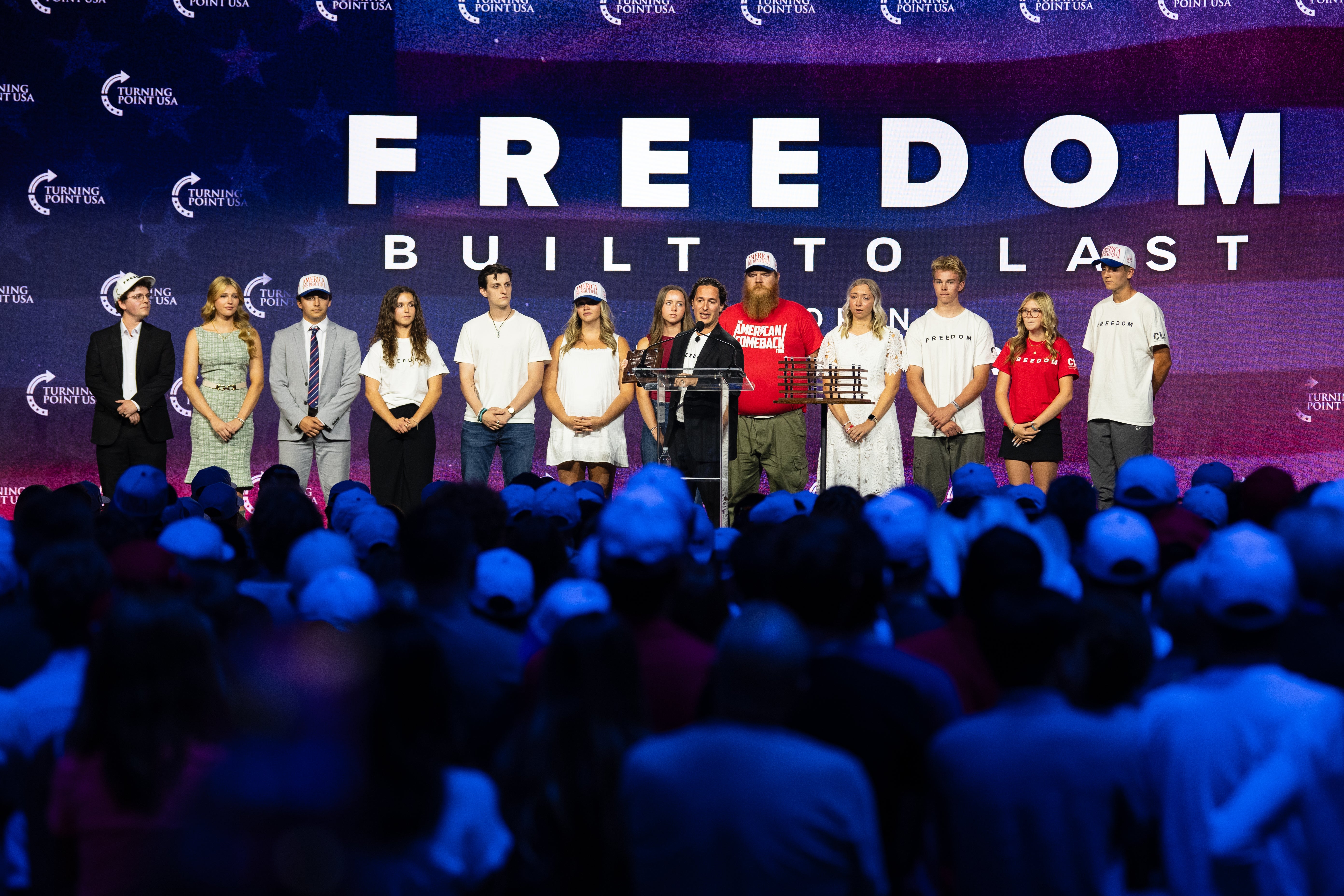 Individuals who were present at the scene of Turning Point USA founder Charlie Kirk's fatal shooting stand together on stage during a Charlie Kirk memorial service at the UCCU Center on September 10, 2026 in Orem, Utah.