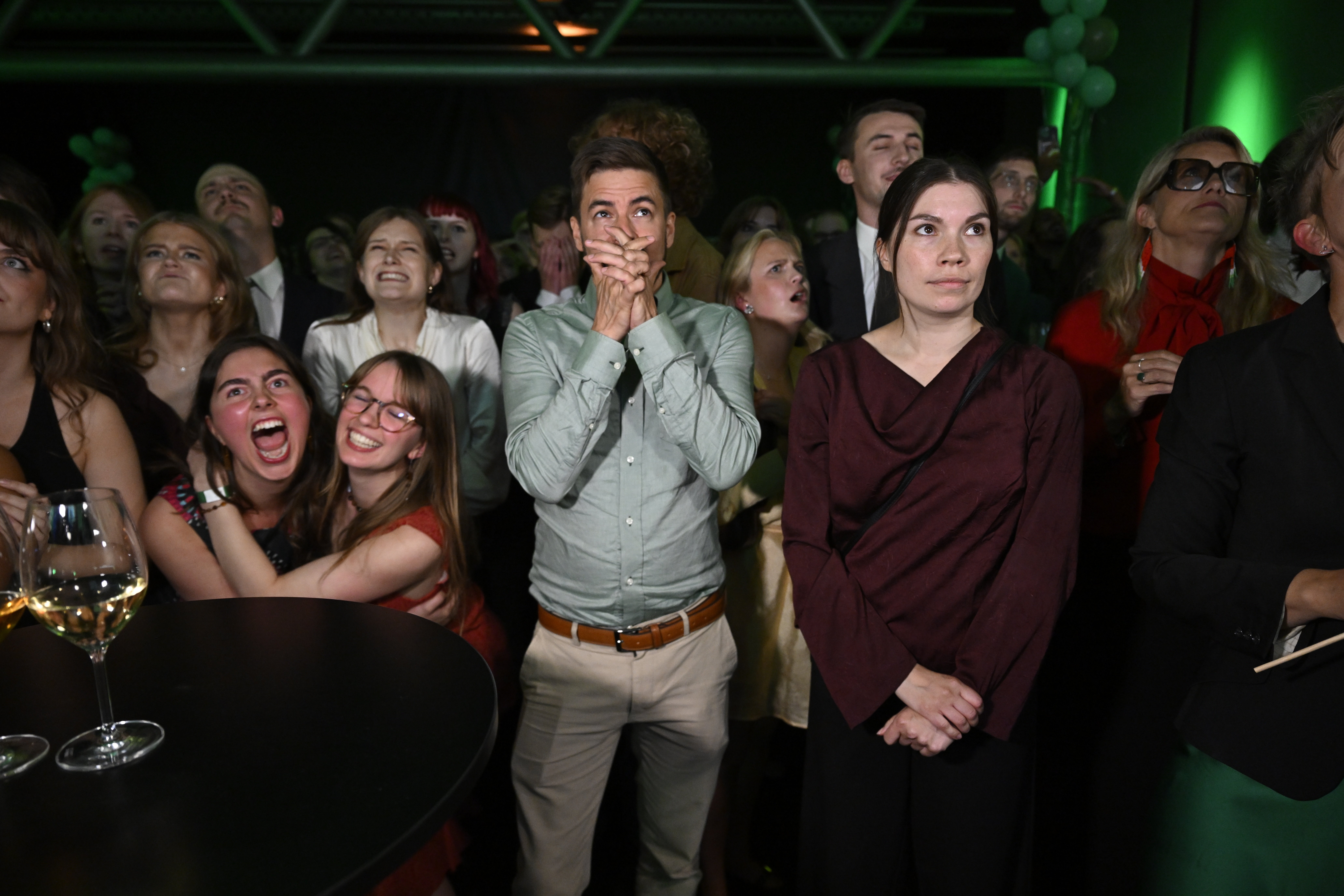 Green Party members react to the presentation of the exit poll at the election night watch party, in Stockholm