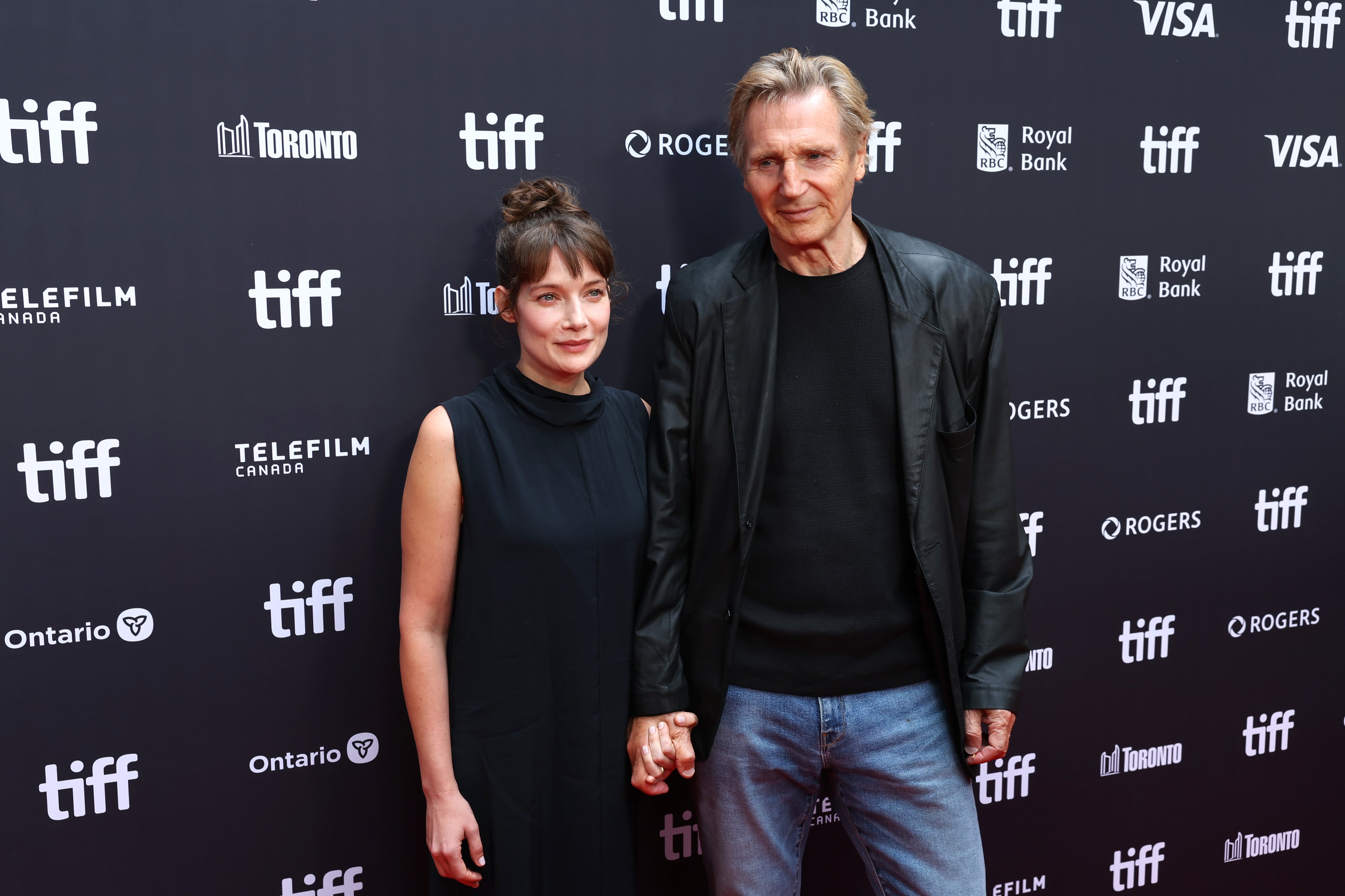 Liam Neeson sparks dating speculation after holding hands with co-star on the red carpet