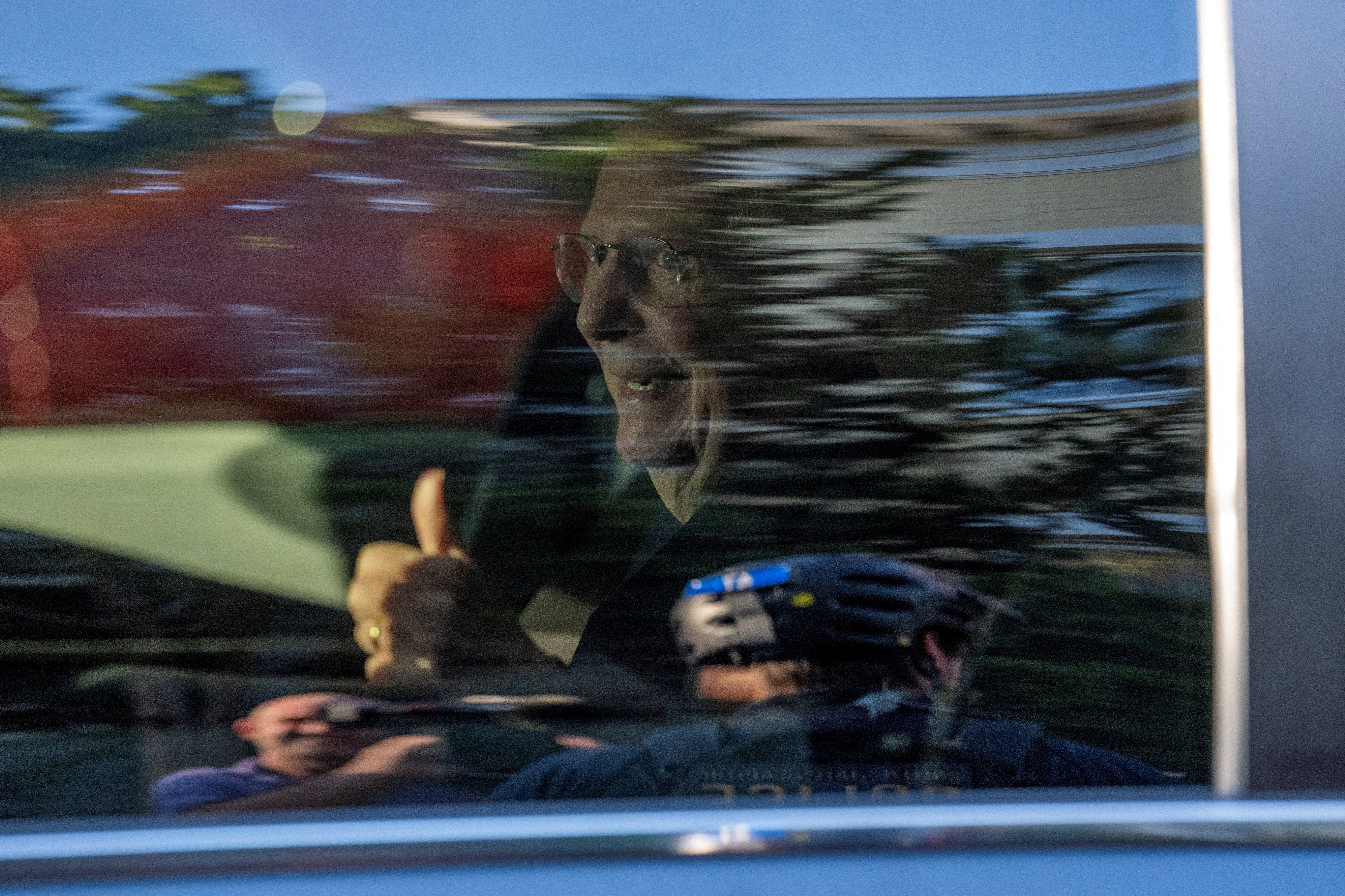 McConnell smiles and gives a thumbs-up to reporters and spectators outside of his D.C. townhome