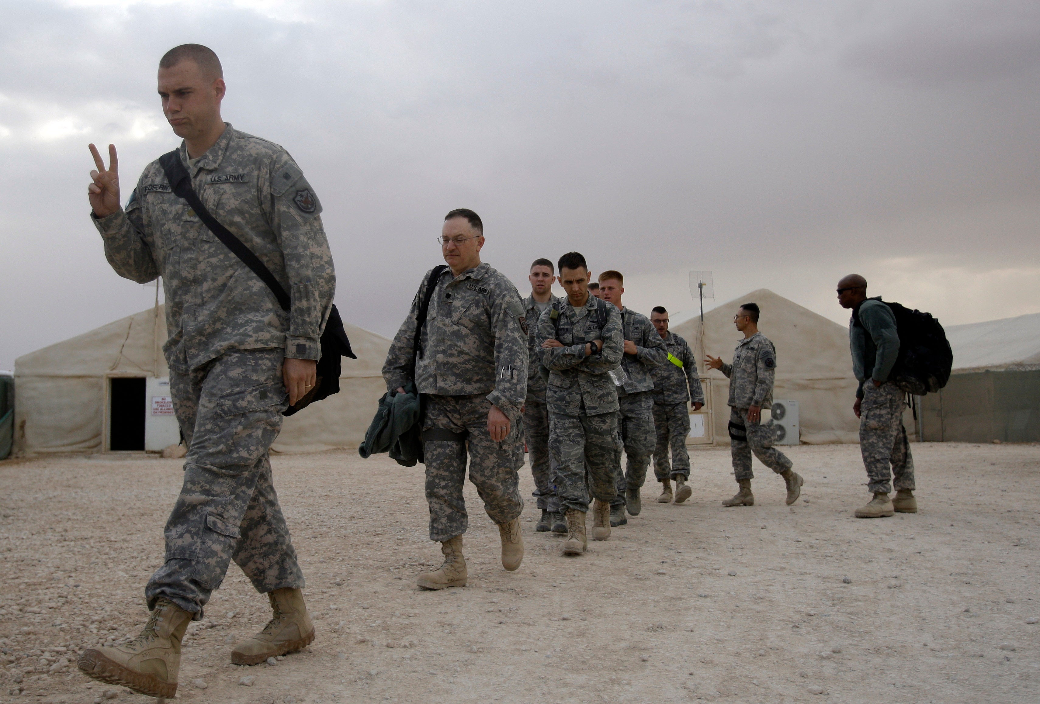 A U.S. army soldier flashes a V for victory sign as he begins his journey home, at the al-Asad Air Base west of Baghdad, Iraq, Nov. 1 , 2011