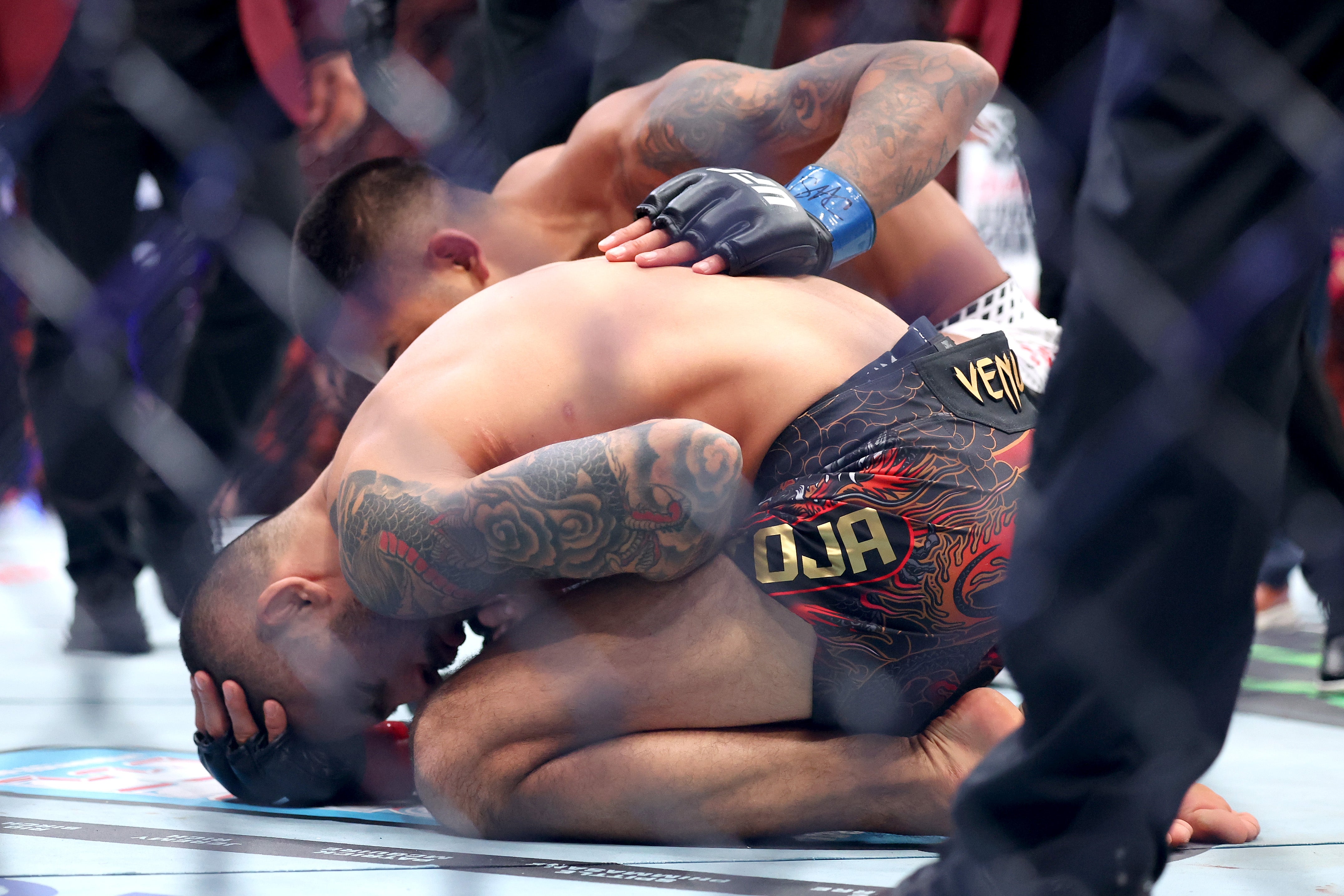Joshua Van (top) checking on Alexandre Pantoja after the latter sustained an injury in their bout