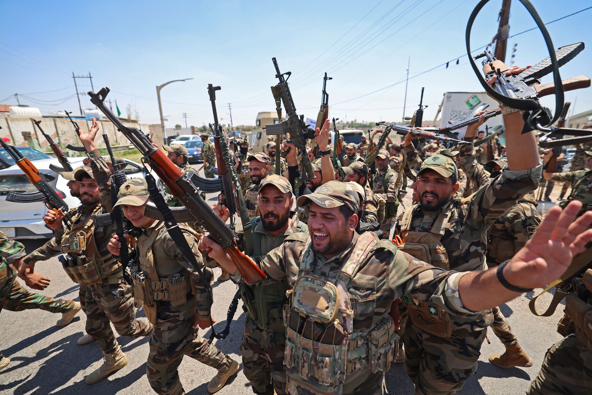 Members of Saraya al-Salam react during a ceremony in the city of Samarra on June 4, 2026, marking their separation from the Sadrist movement and their integration into the Iraqi security forces