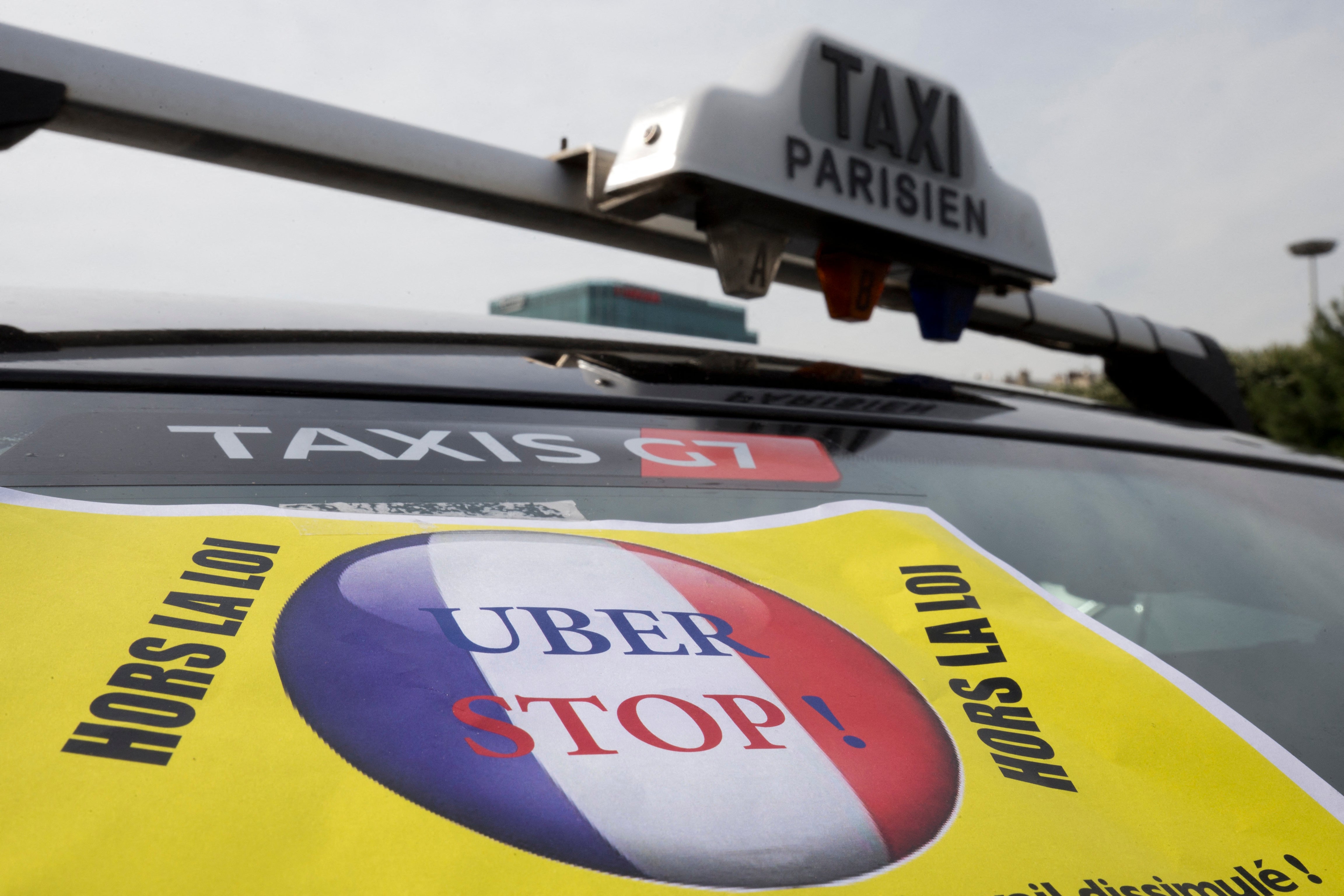 A taxi blocks the area of Porte Maillot in west Paris, on June 26, 2015, with drivers furious at what they see as unfair competition from Uber