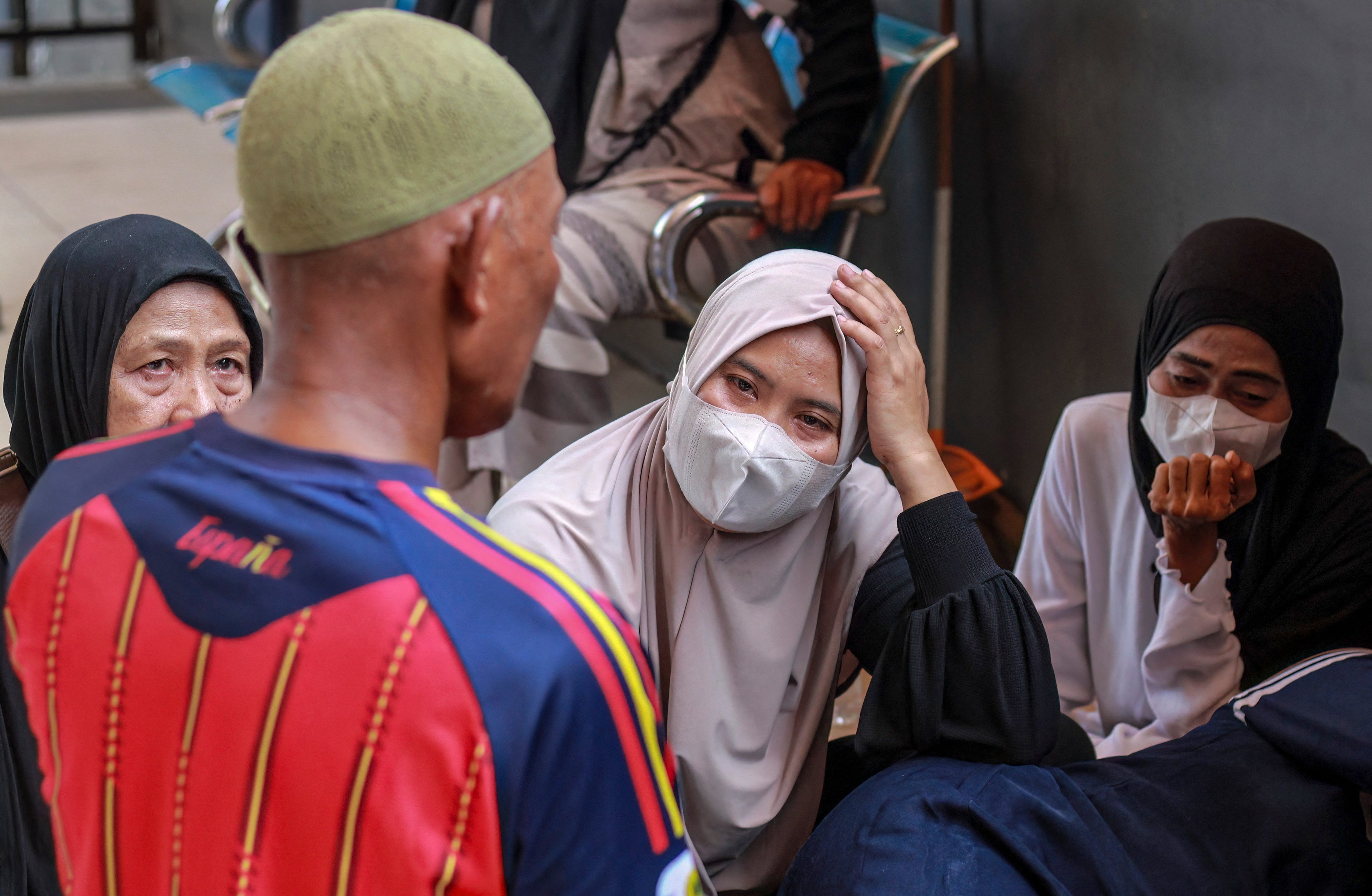 Relatives of victims of the Virgo Transport 8 disaster wait at the port in Banjarmasin, South Kalimantan, Indonesia (AFP/Getty)