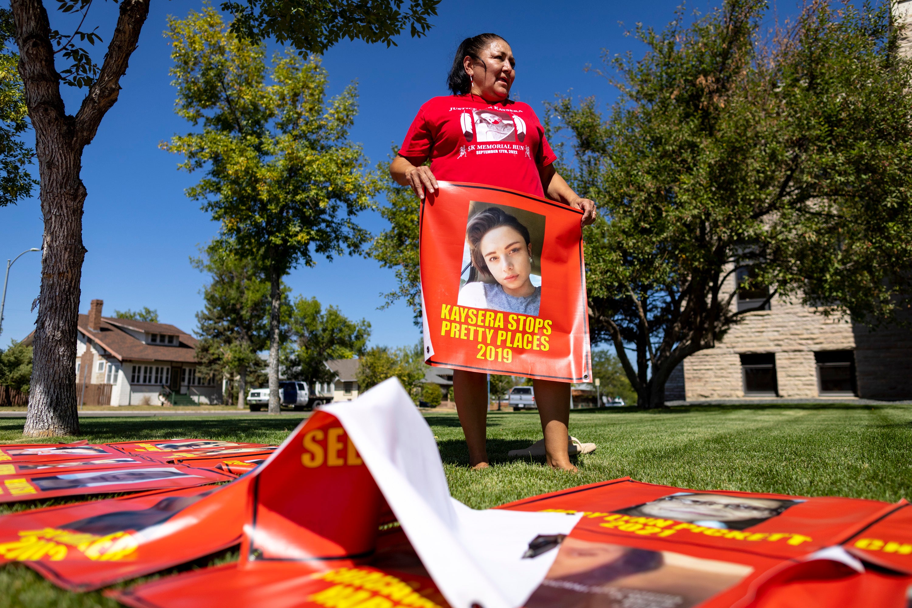 Melissa Lonebear holds a banner with a picture of Kaysera Stops Pretty Places on it during a rally in support of the Missing and Murdered Indigenous People movement at the Big Horn County Building on Aug. 29, 2023