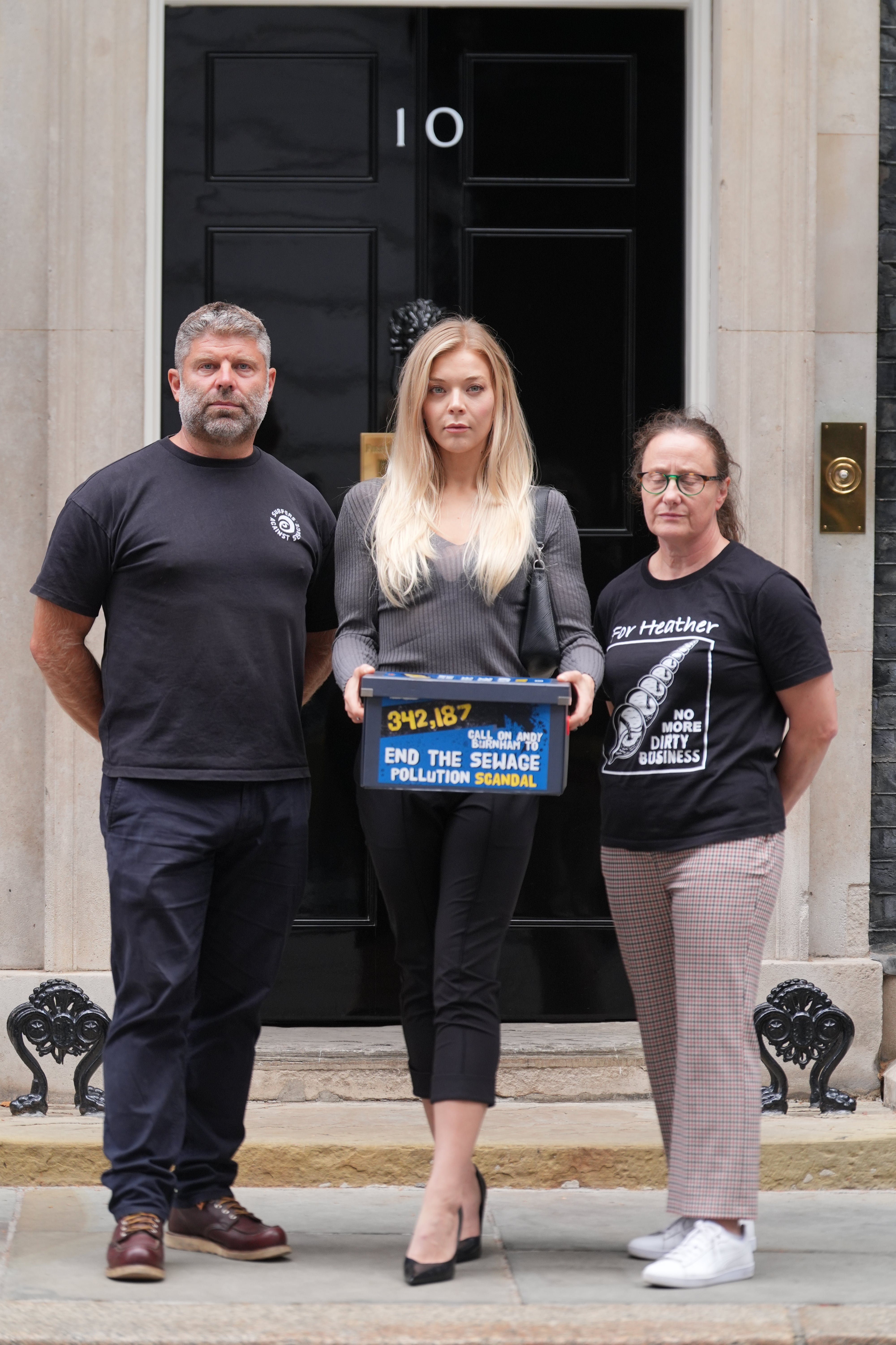 Giles Bristow, singer Becky Hill, and Julie Maughan handing in a petition signed by more than 350,000 people at number 10, Downing Street
