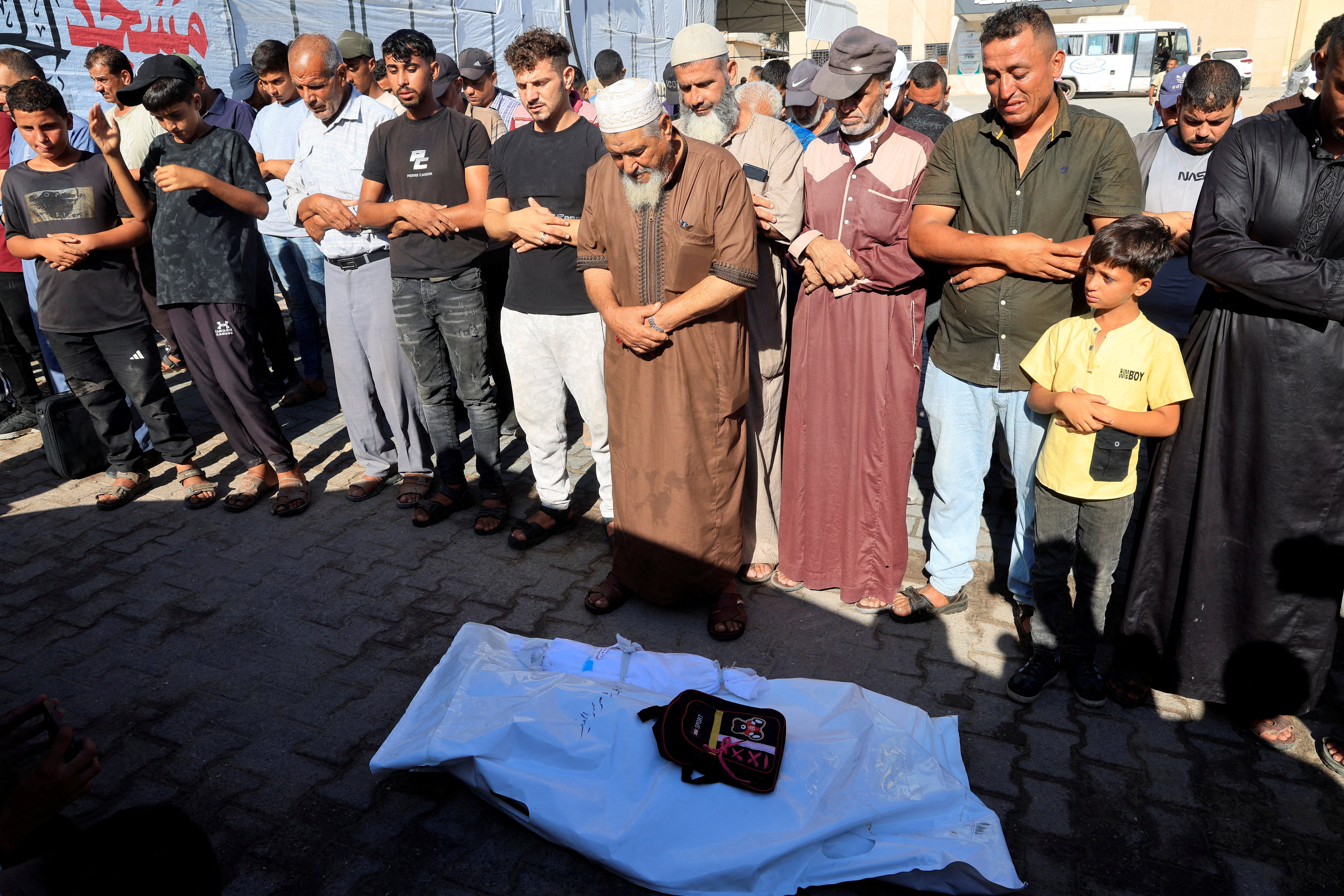 Mourners pray near the body of Palestinian girl Amal Al-Mughair, 8, who was killed in an Israeli strike on her tent on Tuesday, according to medics, in Khan Younis, in the southern Gaza Strip, September 16, 2026