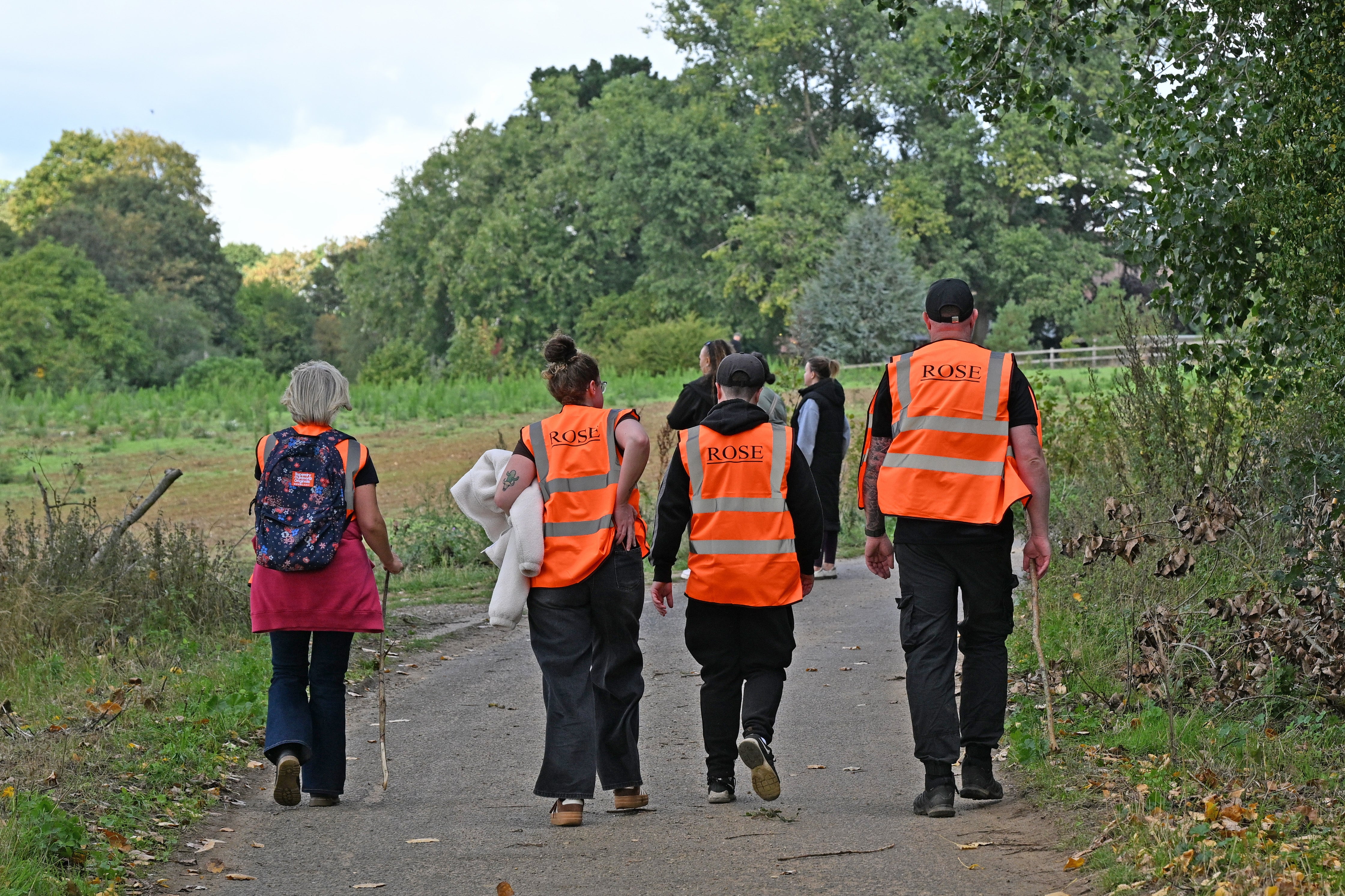 Local residents join police officers as they continue their search near Merriam Close, Brantham