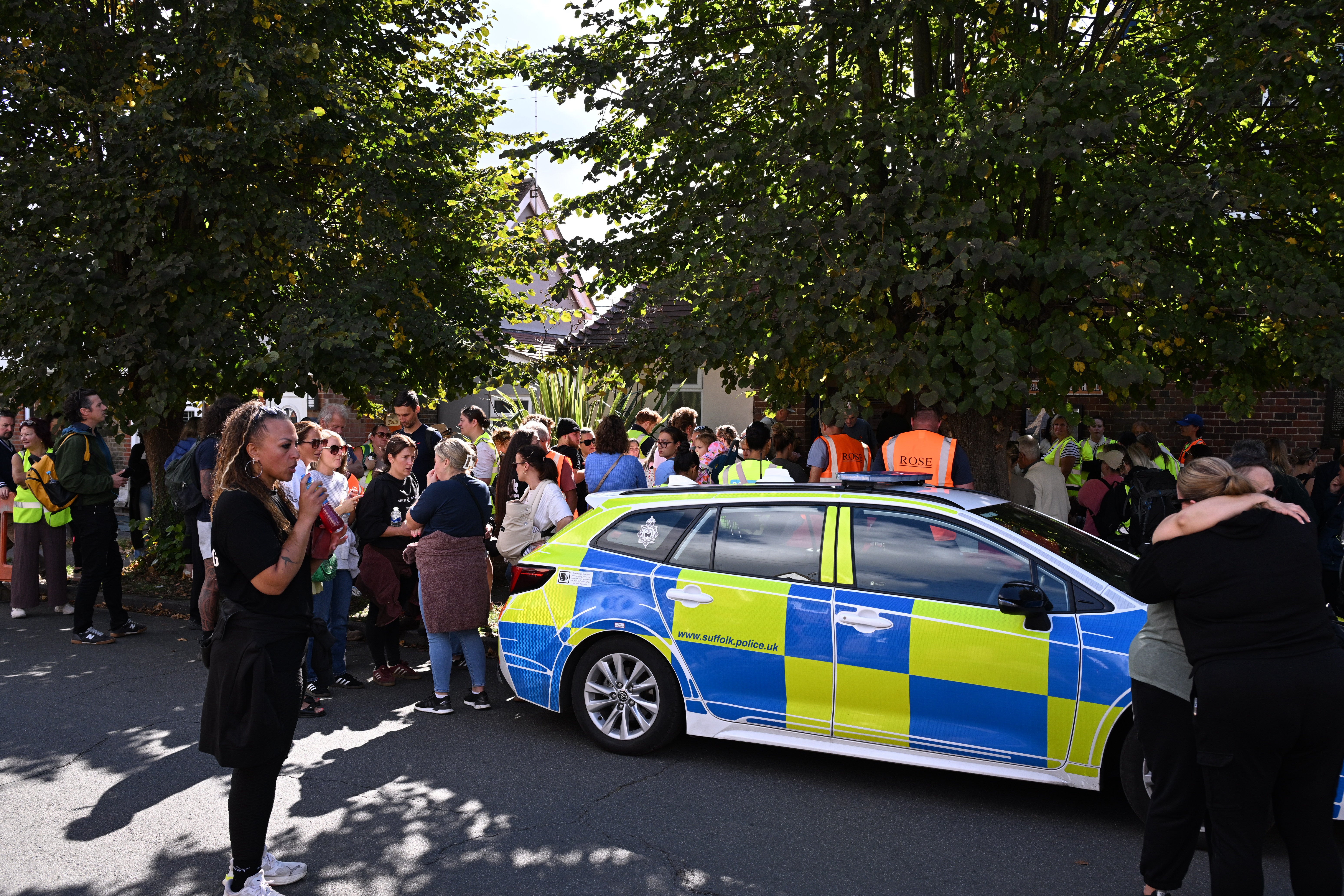 Local residents wait outside Brantham Village Hall