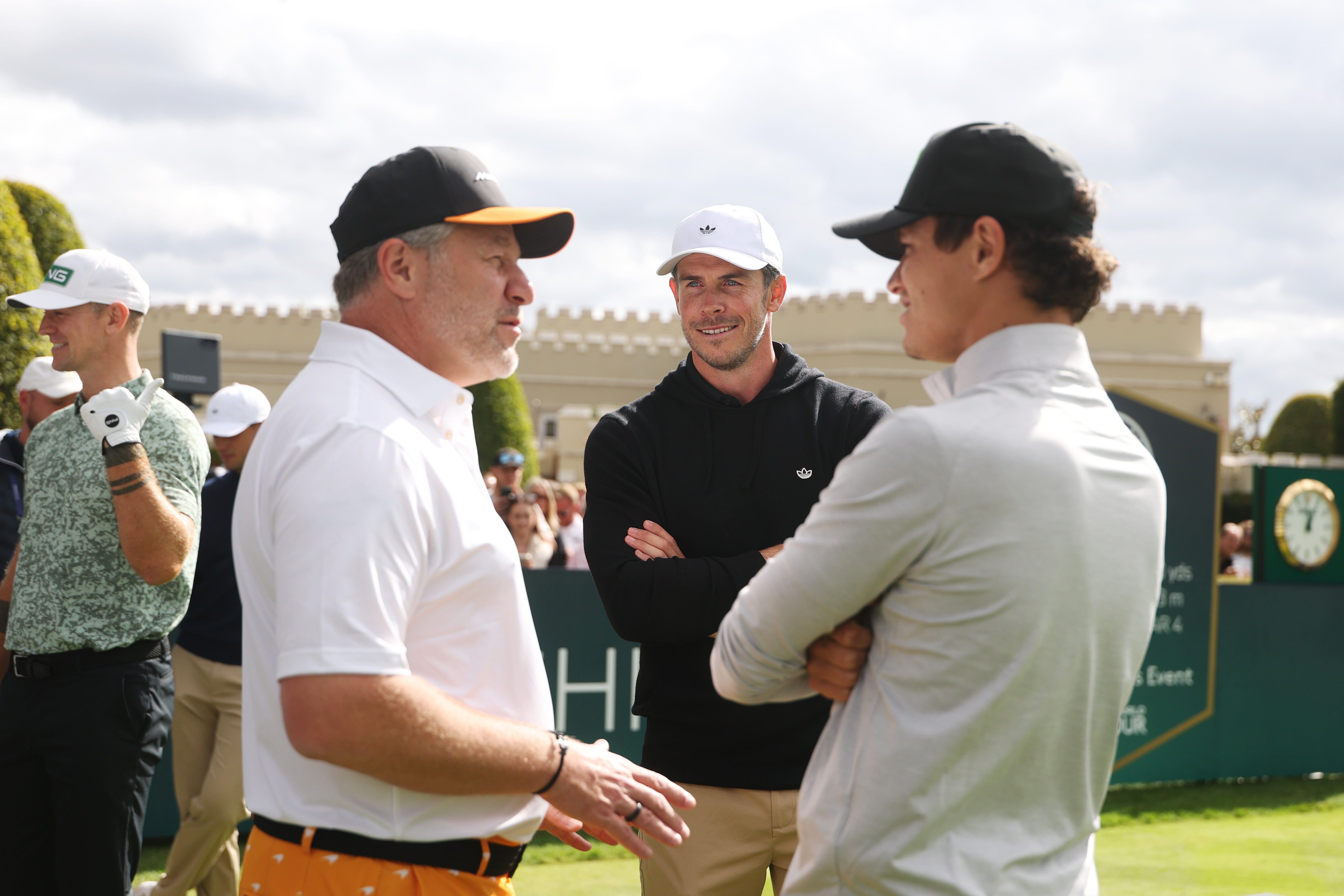 Gareth Bale interacts with Zak Brown and Lando Norris during the Pro-Am prior to the BMW PGA Championship at Wentworth Golf Club (Getty)
