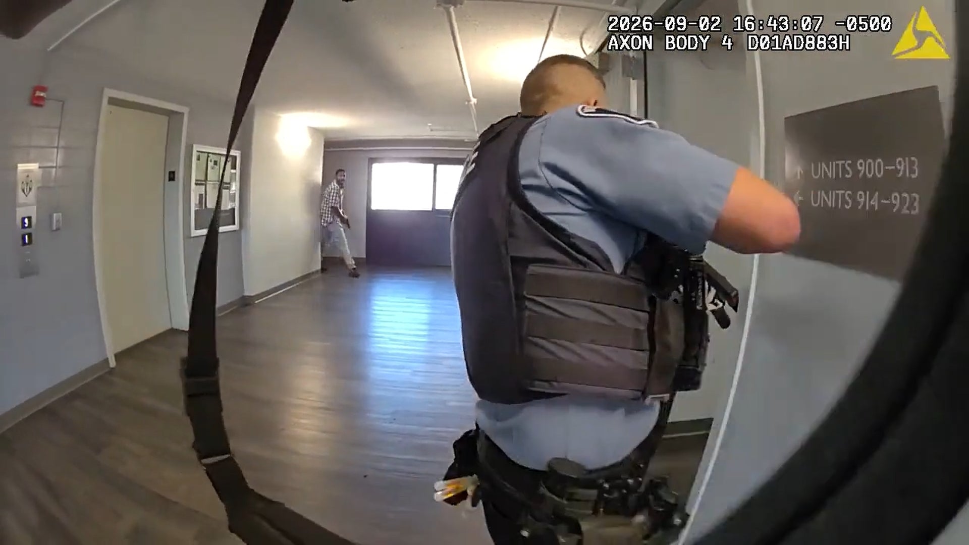 This image made from body camera video provided by the Minneapolis Police Department of a Wednesday, Sept. 2, 2026, shooting shows Minneapolis police Officer Joseph Michnowski looking down an apartment hallway as Carlton Johnson emerges with a handgun