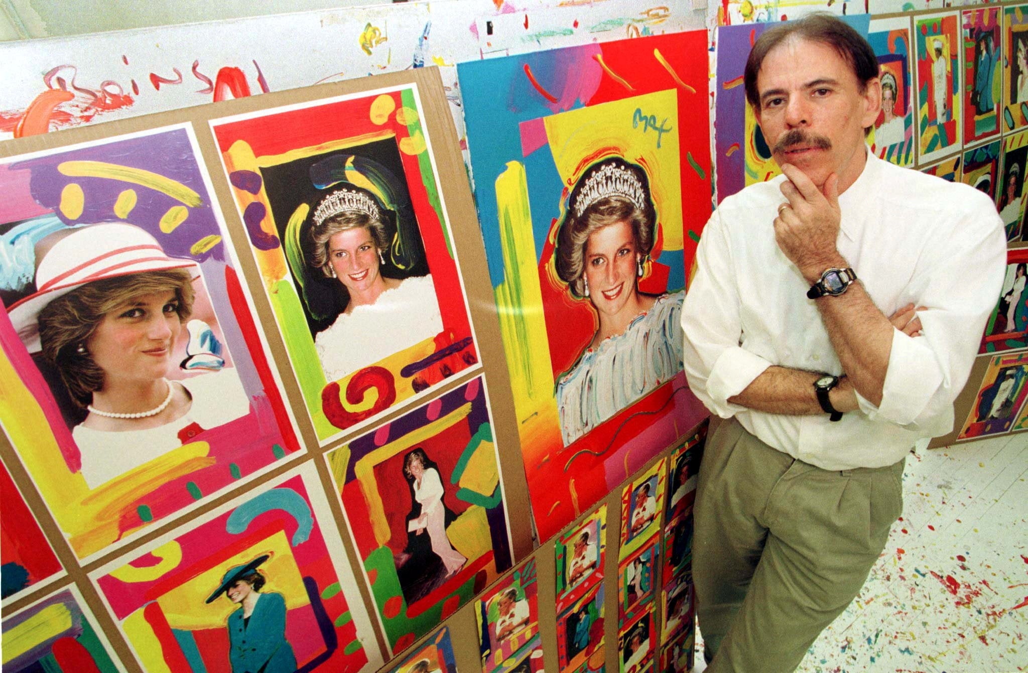 Peter Max poses near pictures of Diana, Princess of Wales, in his New York studio on 25 August 1998 (Reuters)