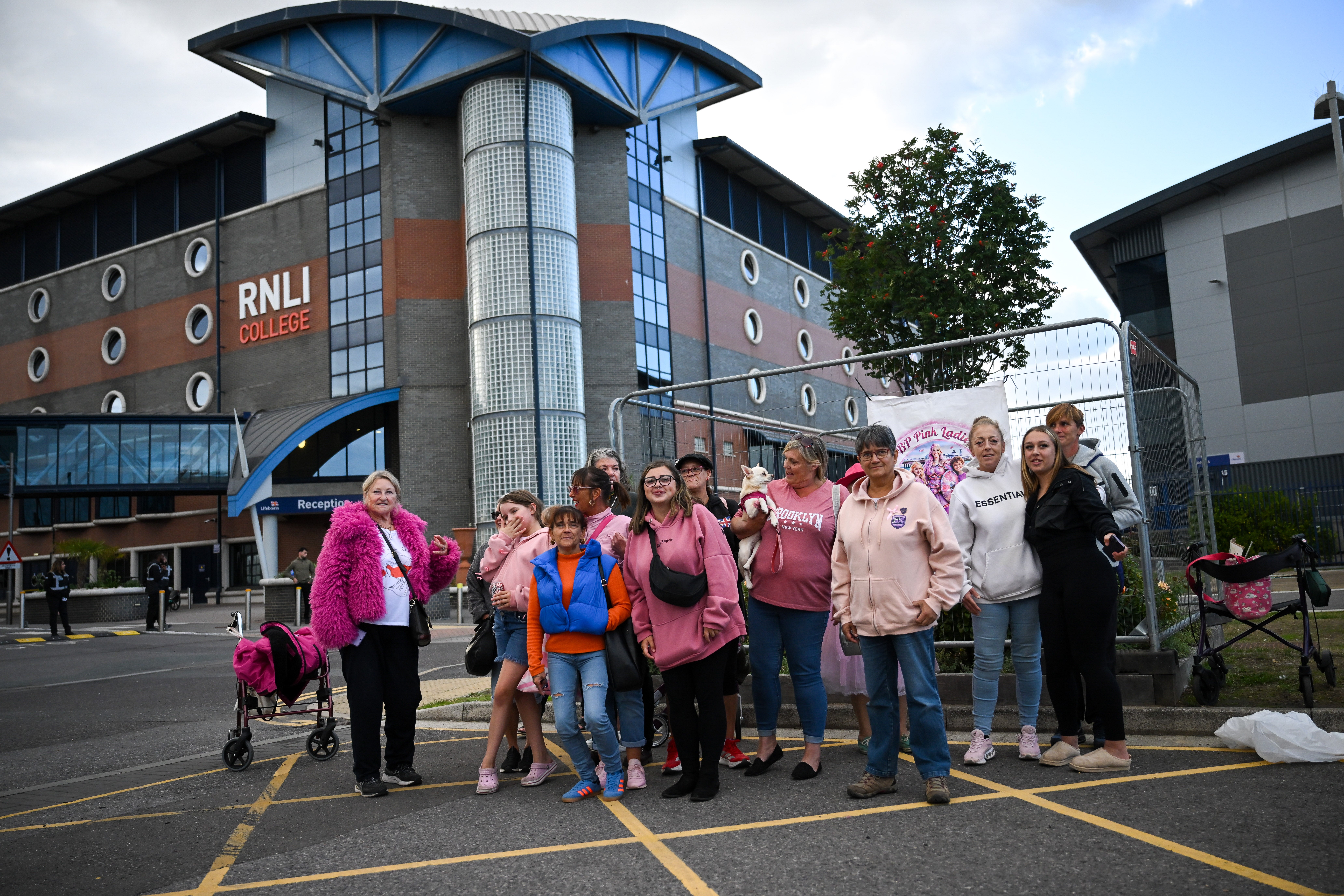 Women and children pose during a Patriot Platform silent vigil at the RNLI station in Poole