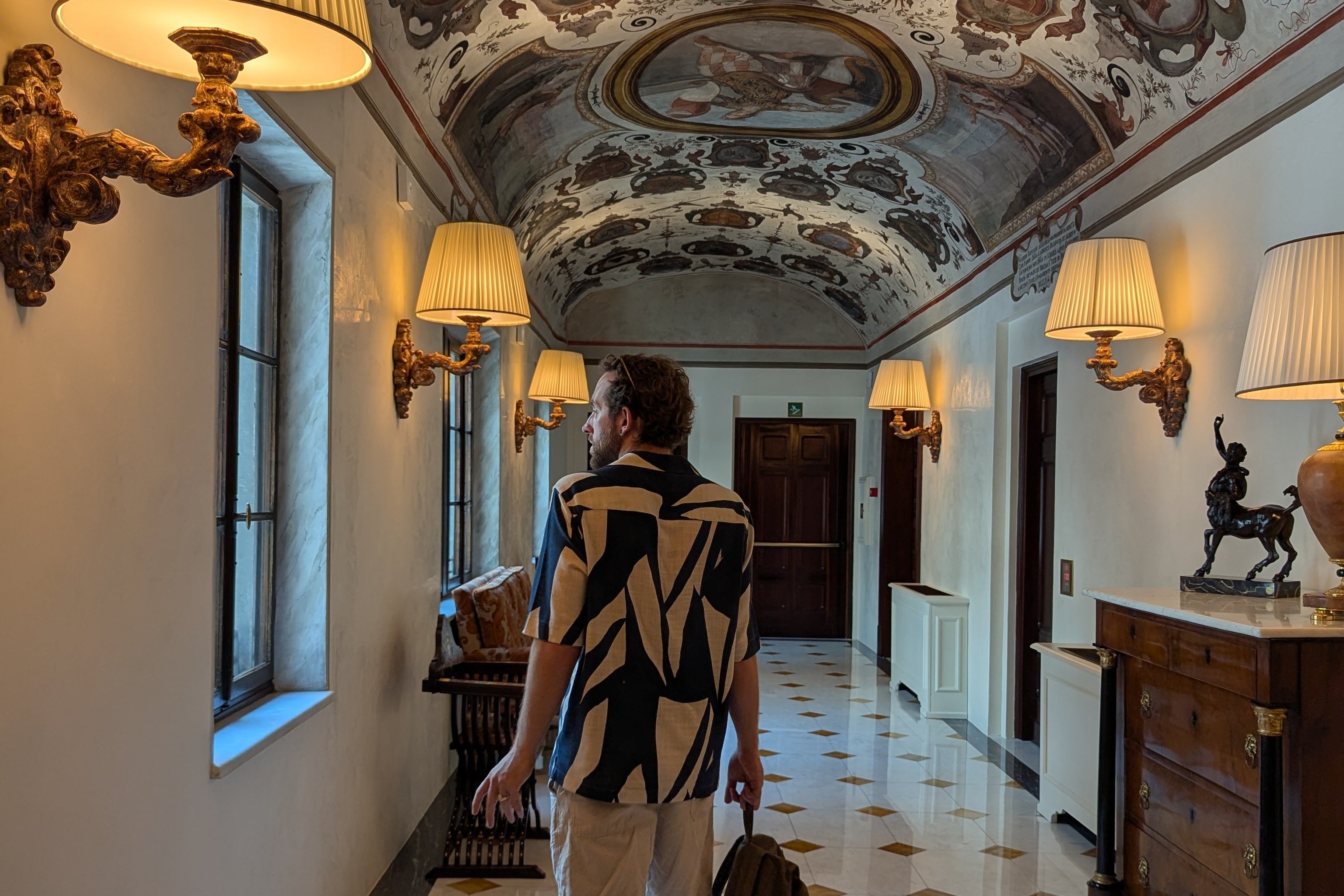 Assistant travel editor Emilee Tombs' husband explores the frescoed corridors of Four Seasons Firenze in Florence (Emilee Tombs)