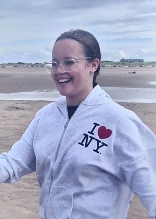 Lillia is white, slim, around 5ft 5in tall, wears glasses, and has light brown hair