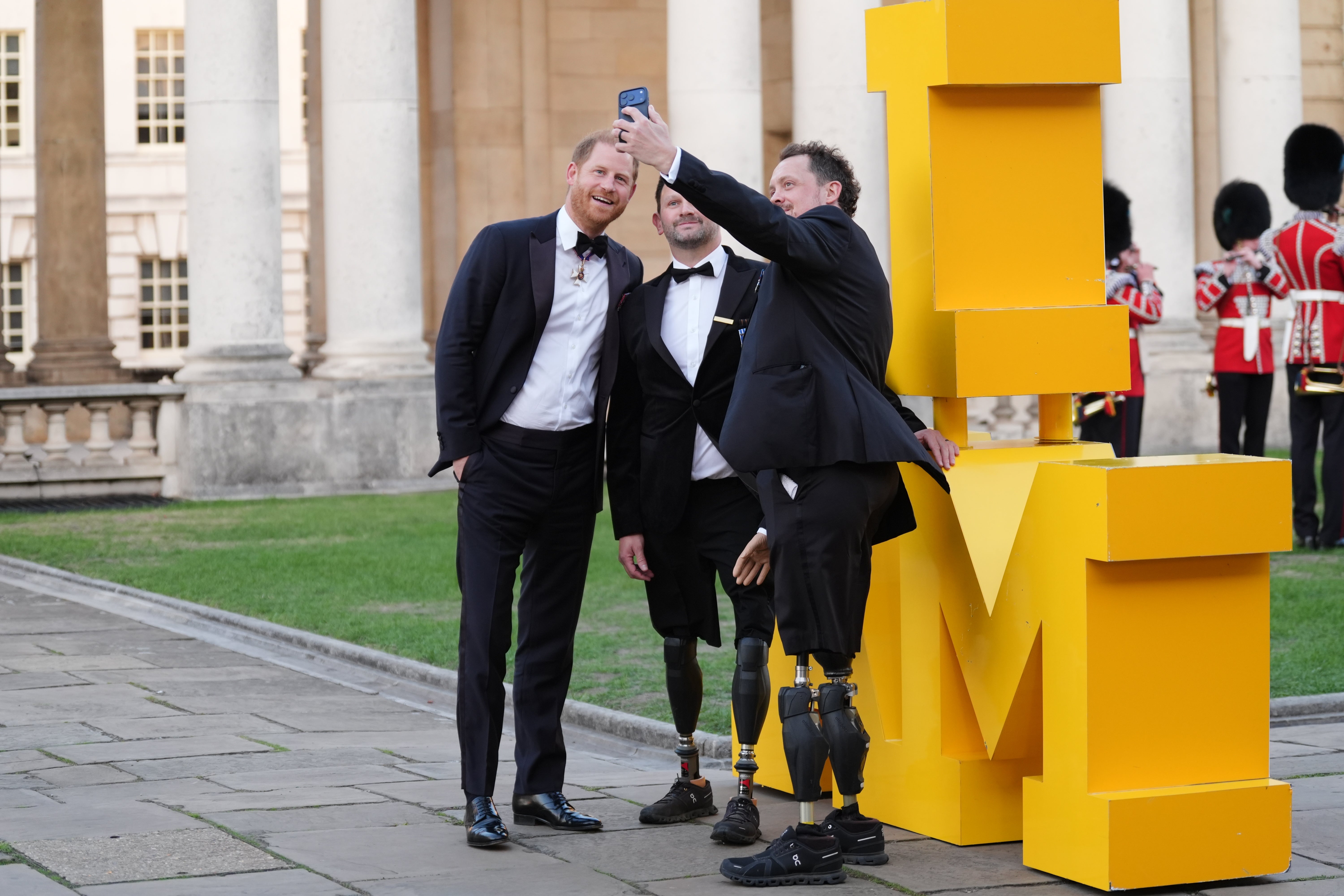 The Duke of Sussex has a selfie taken with Steve Arnold (centre) and Josh Boggi, as he arrives at the inaugural Invictus Spirit Awards (Ben Whitley/PA) (PA Wire)
