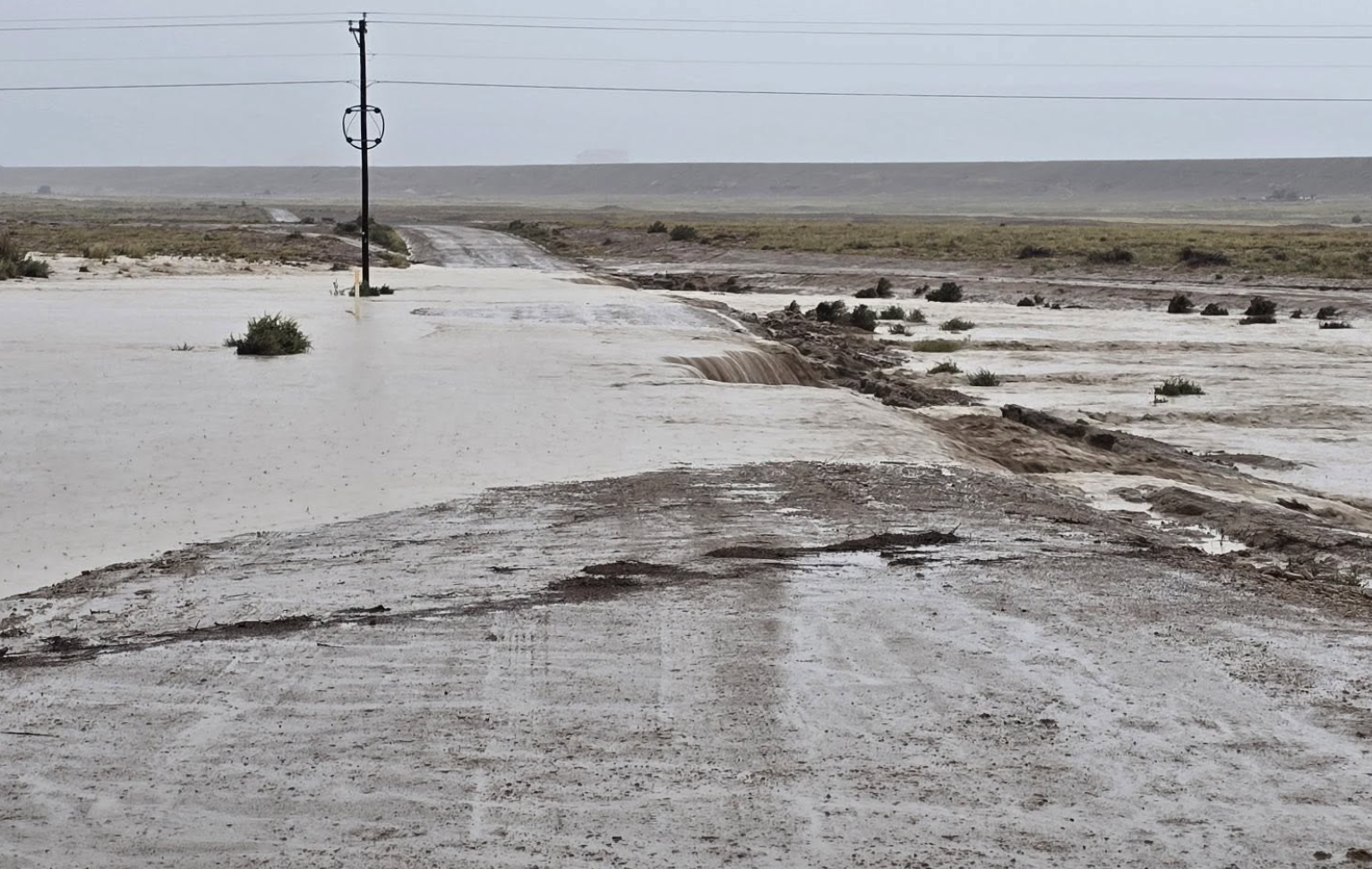 A flooded road near Newcomb, New Mexico, on September 17, 2026. Three people, including one child, were killed on September 16 after they were swept away by flood waters near Newcomb, which is part of the Navajo Nation