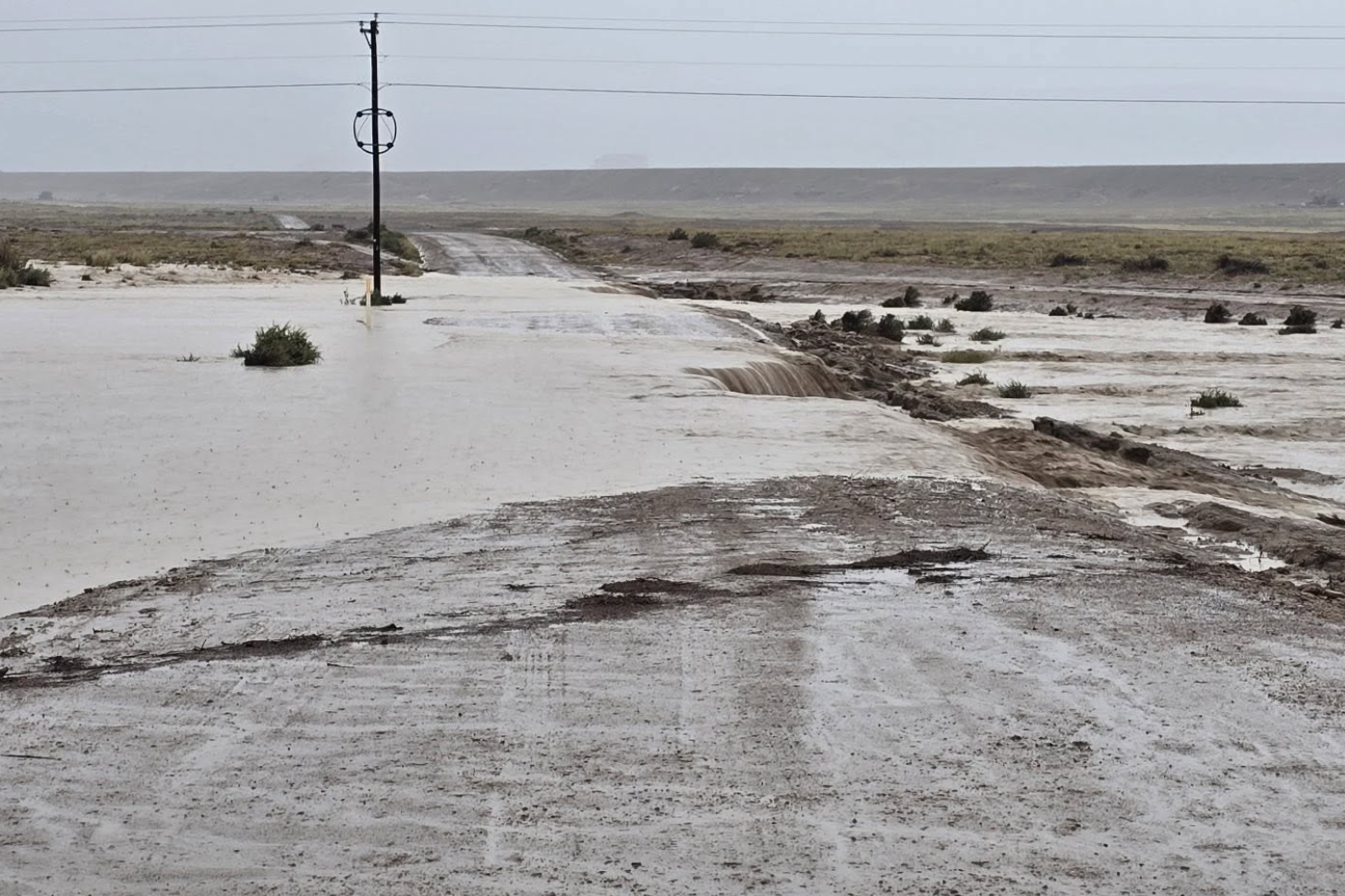 A flooded road near Newcomb, New Mexico, on September 17, 2026. Three people, including one child, were killed on September 16 after they were swept away by flood waters near Newcomb, which is part of the Navajo Nation (Navajo Division of Transportation)
