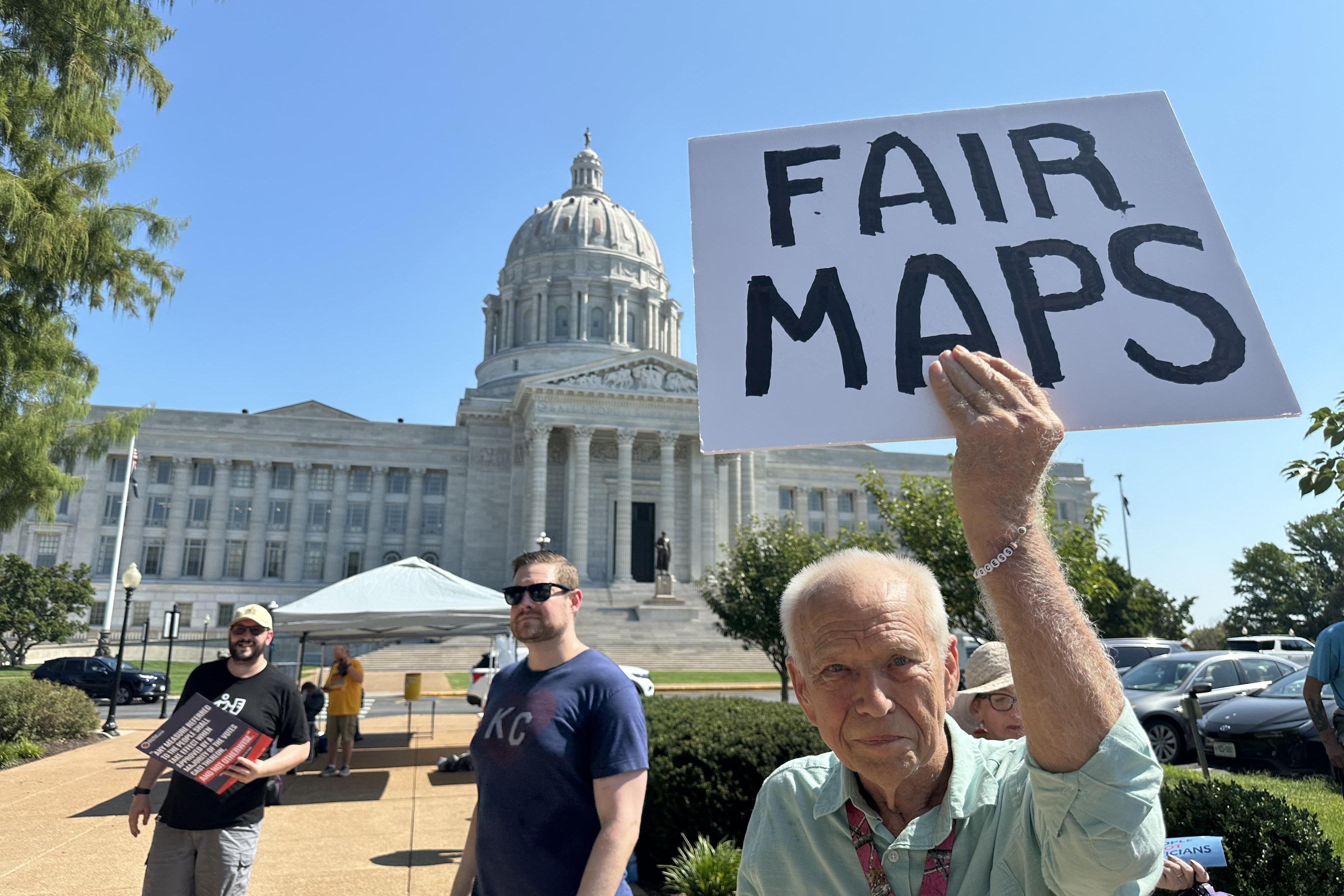 A protester holds a sign in opposition to Missouri’s congressional redistricting plan