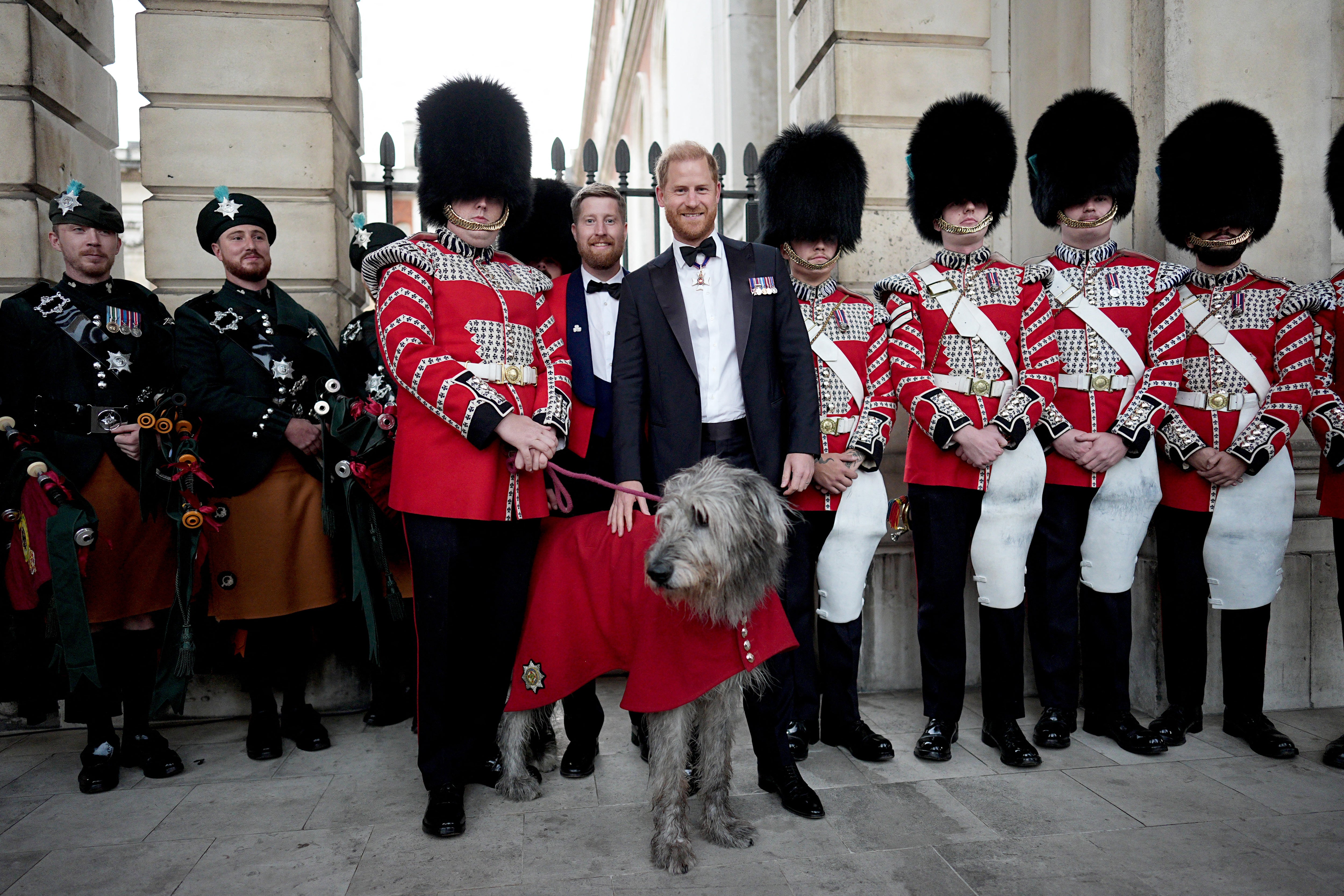 Britain's Prince Harry, Duke of Sussex poses with members of the Band of the Irish Guards and their mascot, Irish wolfhound dog 'Seamus' (AFP/Getty)