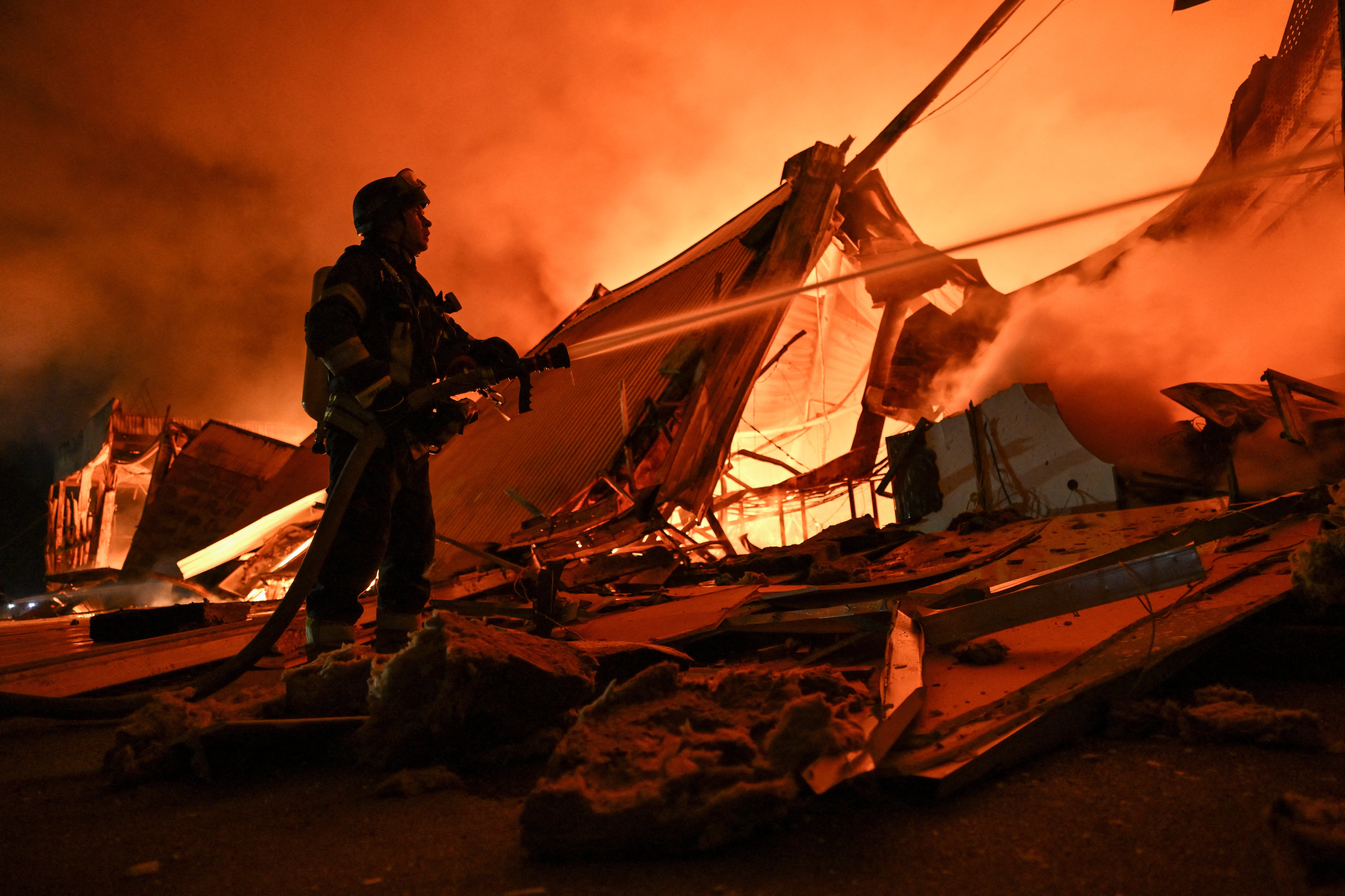 A firefighter works at the site of a shopping mall which was hit by a late evening Russian drone strike in Zaporizhzhia, Ukraine September 17, 2026 (Reuters)