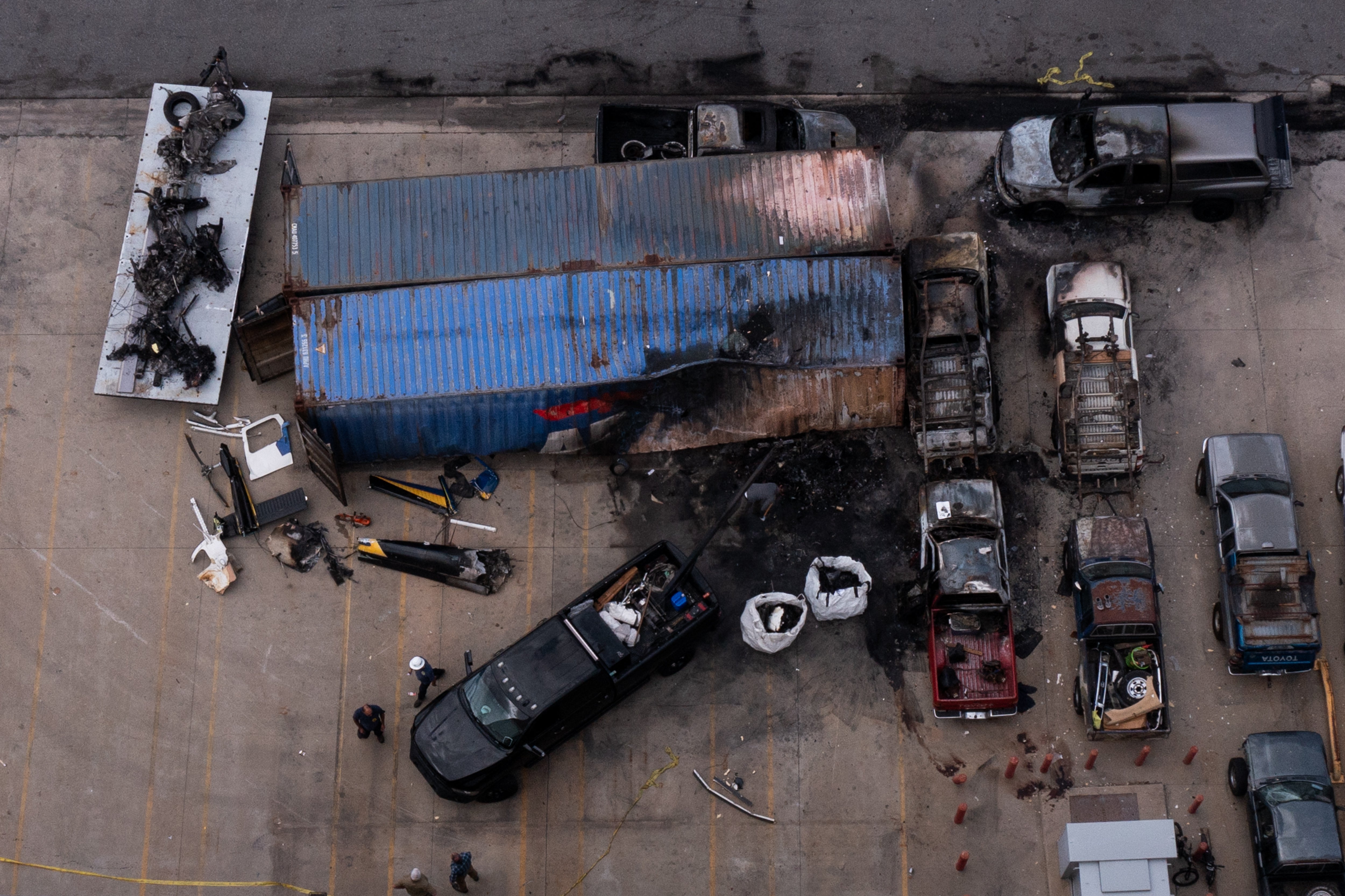 An aerial image shows workers as wreckage is loaded onto a flat bed while NTSB investigators work at the site of an NBC4 TV news helicopter that crashed in Chatsworth neighborhood of Los Angeles (AFP/Getty)