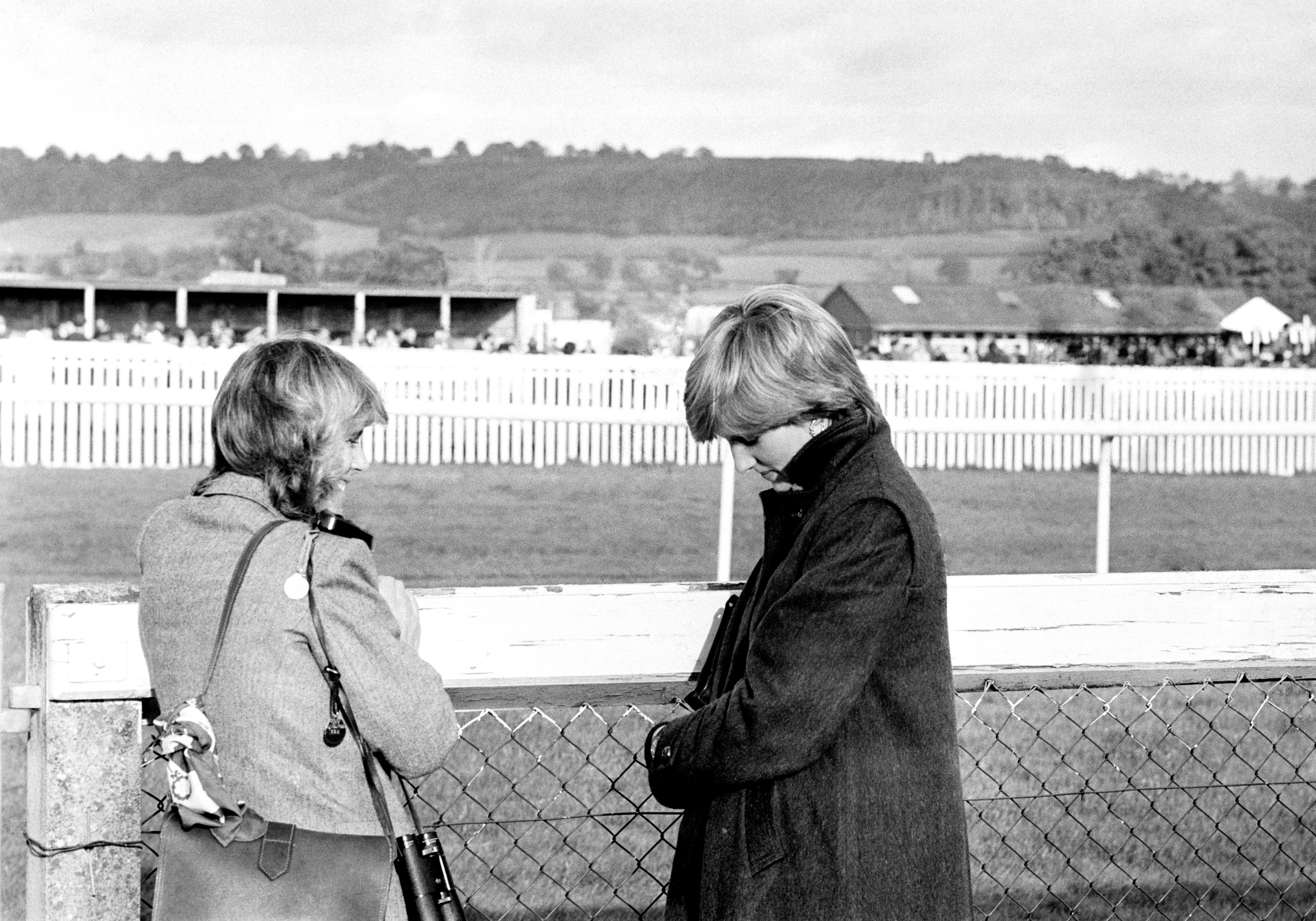 Camilla Parker-Bowles (left), who is now the Queen, and Lady Diana Spencer (later the Princess of Wales) at Ludlow racecourse in 1980 watching the Amateur Riders Handicap Steeplechase in which Charles was competing (PA)