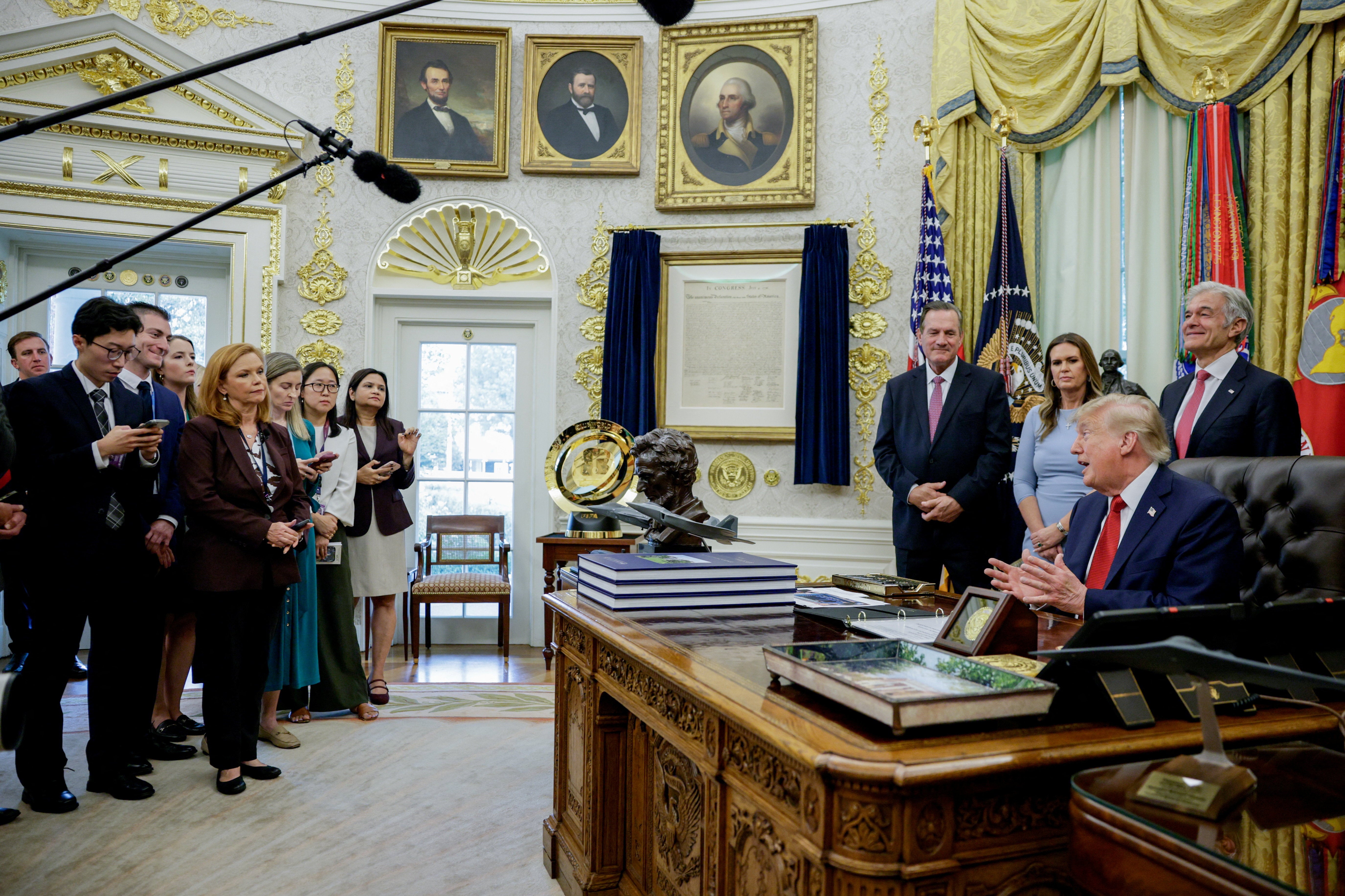 Trump takes questions from reporters Friday after saying he will ban certain media outlets that do not flatter him from having access to the White House in the future
