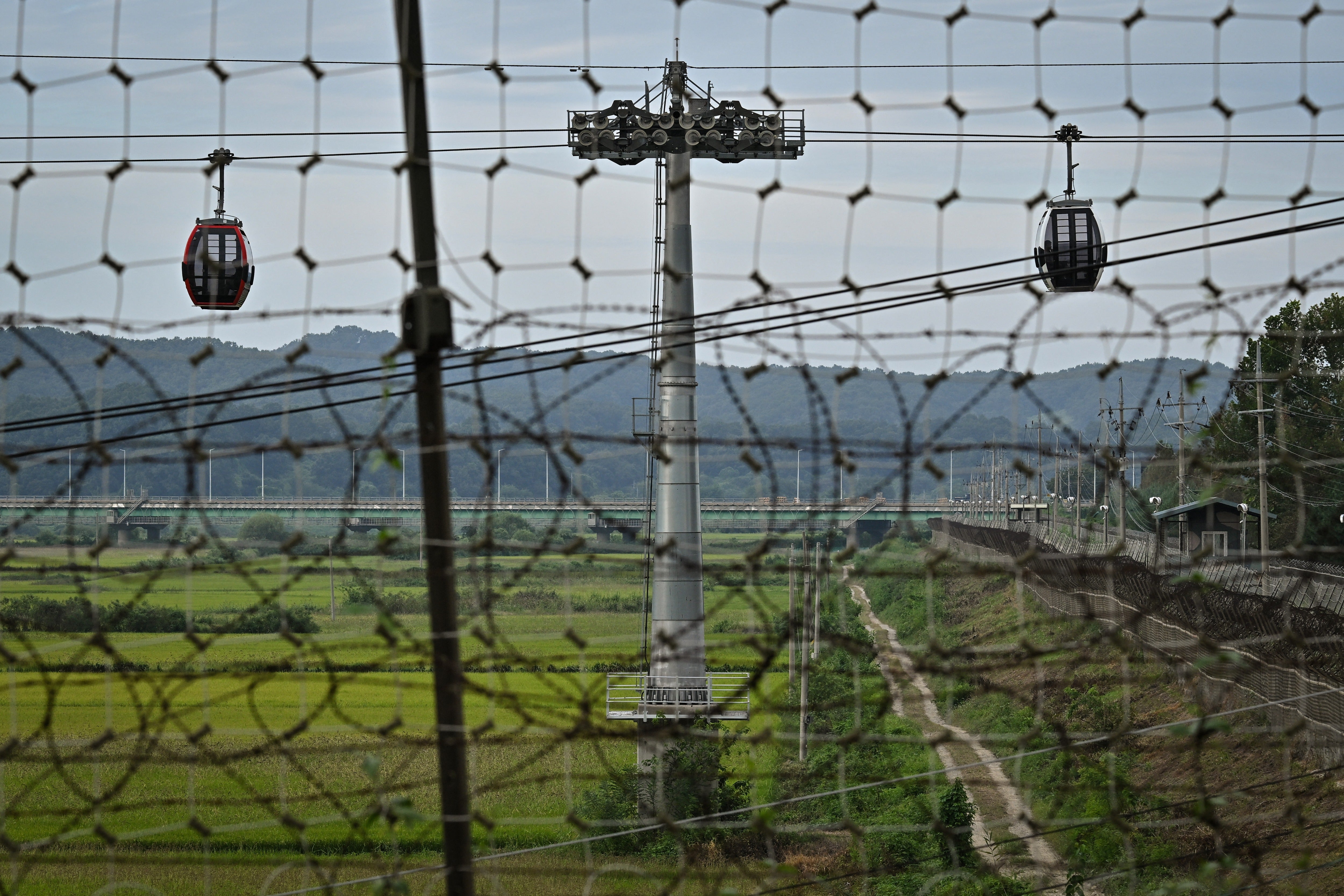 Visitors ride the Paju Imjingak Peace Gondola over the Civilian Control Zone in Imjingak park, near the Demilitarized Zone (DMZ) dividing South Korea and North Korea (AFP via Getty Images)