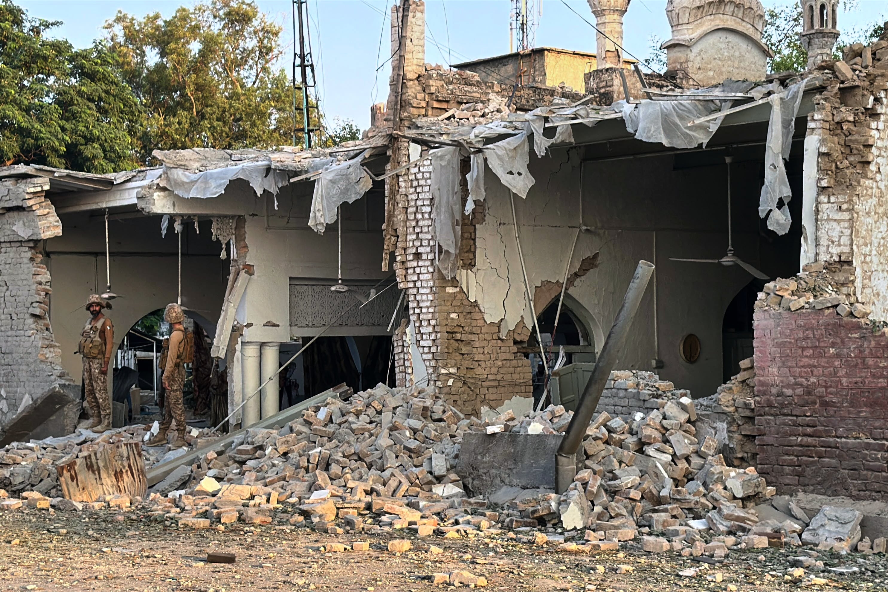 Army soldiers stand over the rubble at the site of a powerful bomb exploded at a mosque in Kohat, in northwestern Pakistan (AP)