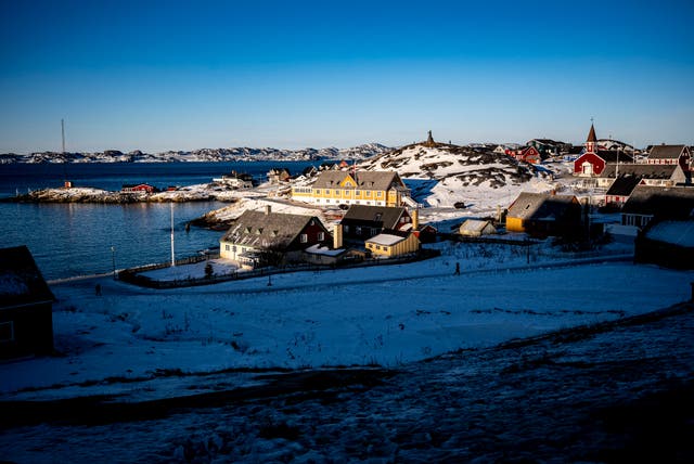 Low sun illuminates buildings in Nuuk. Greenland operates as a semi-autonomous territory of Nato member Denmark