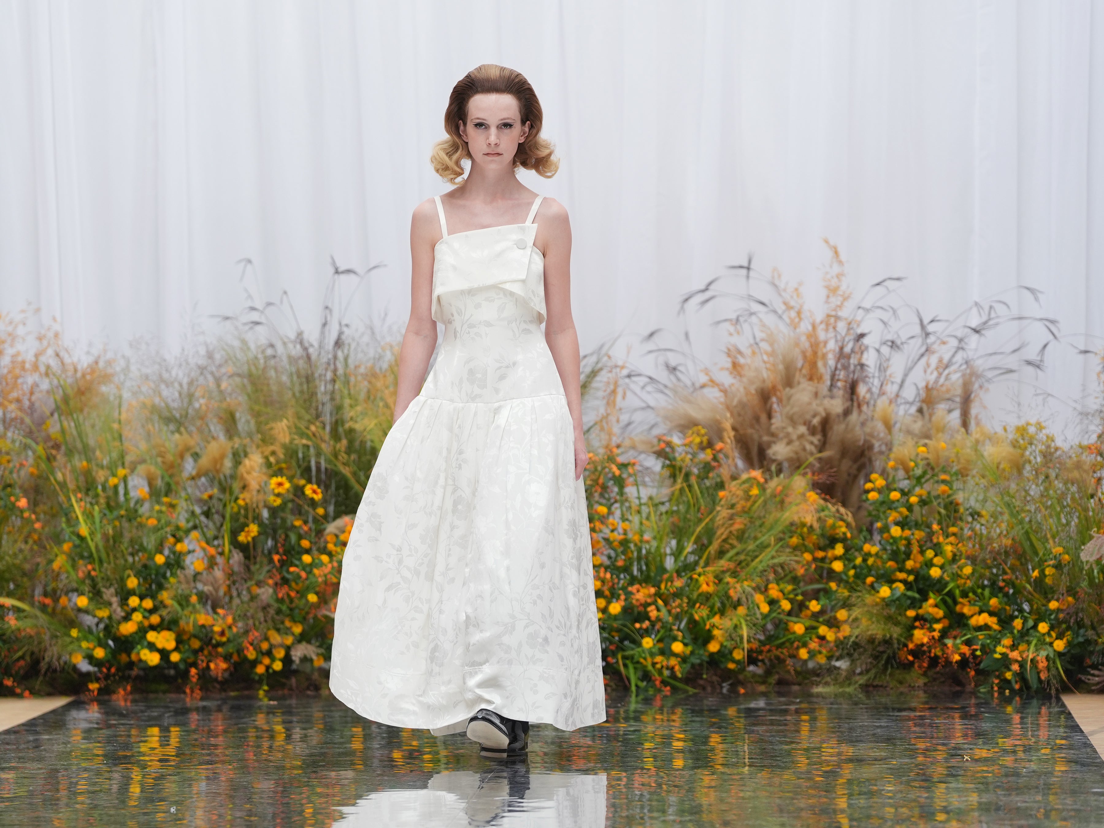 A jacquard floral white gown on the runway (Yui Mok/PA)