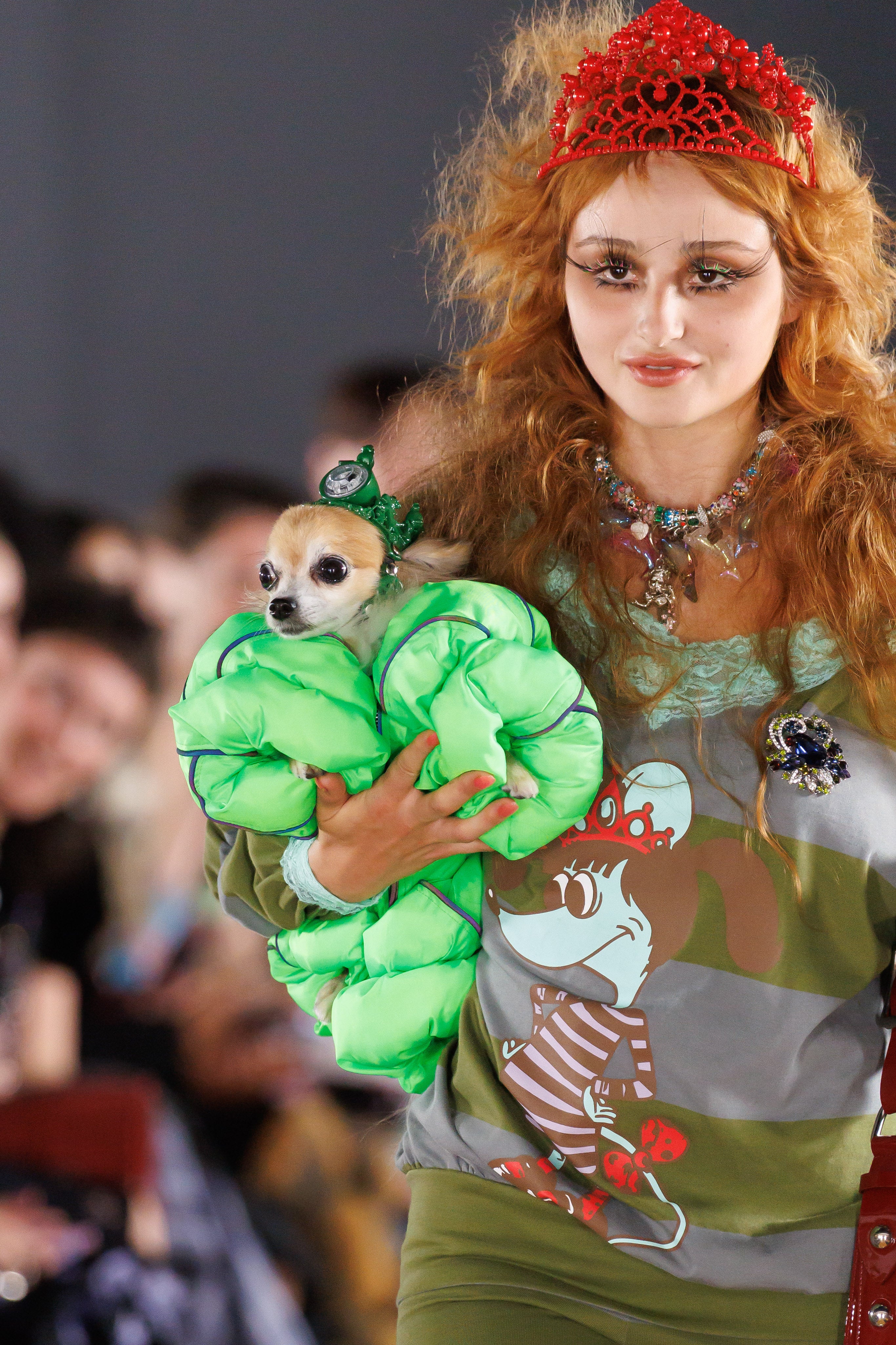 A Chopova Lowena model holding the smallest canine model in a green puffer jacket (Jason Lloyd Evans/PA)