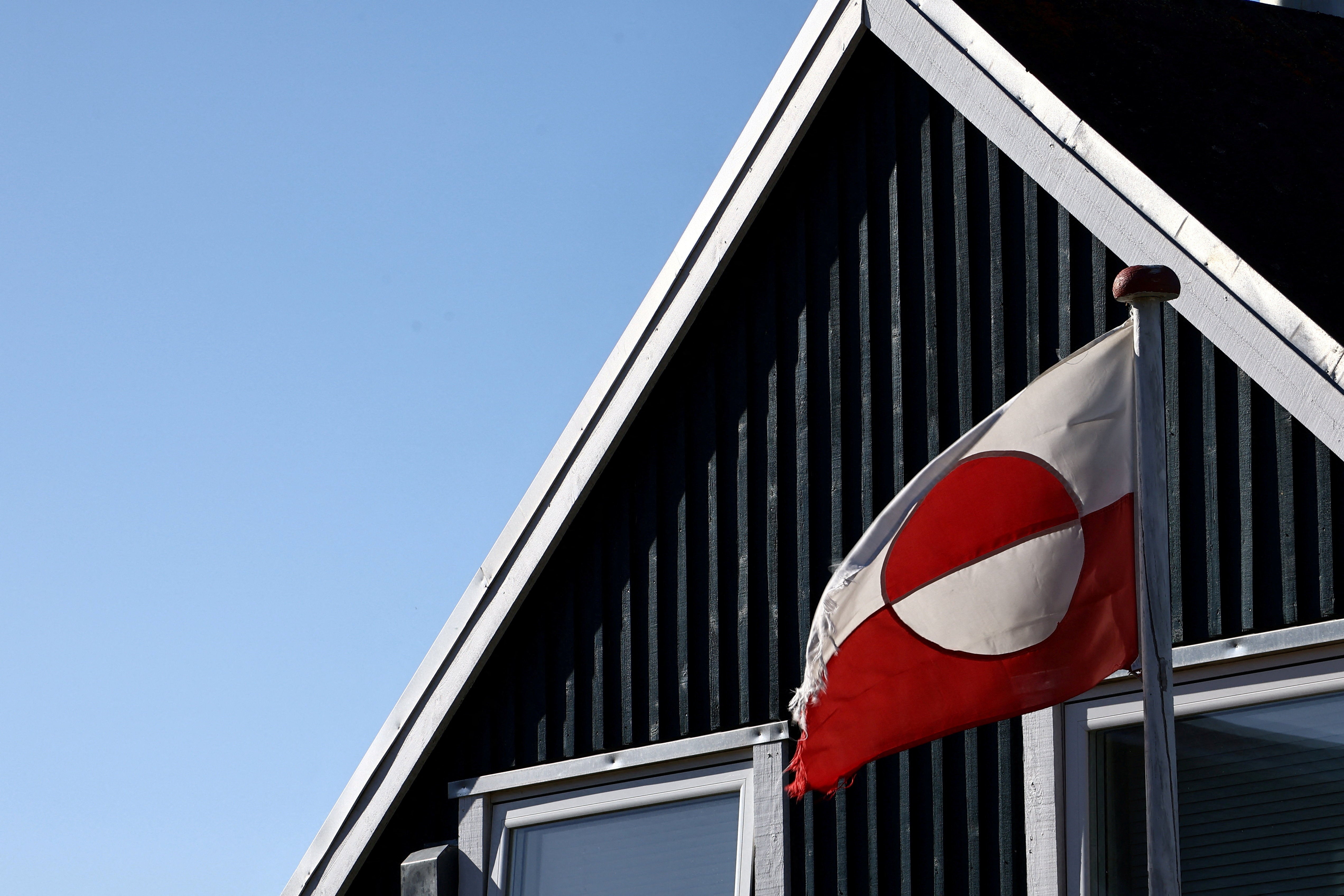 The Greenland flag flutters in front of a house in Nuuk, Greenland