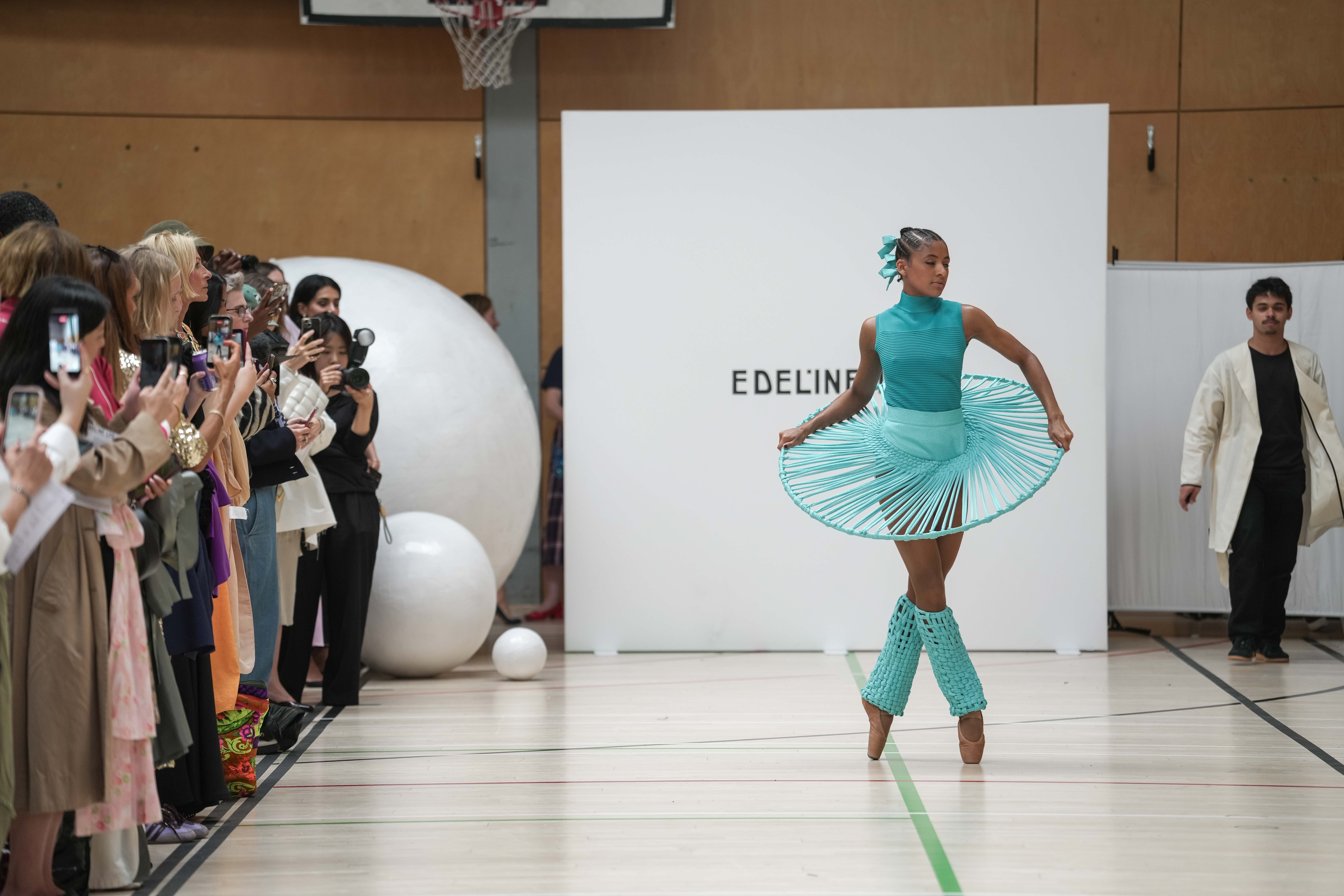 A ballet dancer in a turquoise design on the Edeline Lee runway (Jeff Moore/PA)