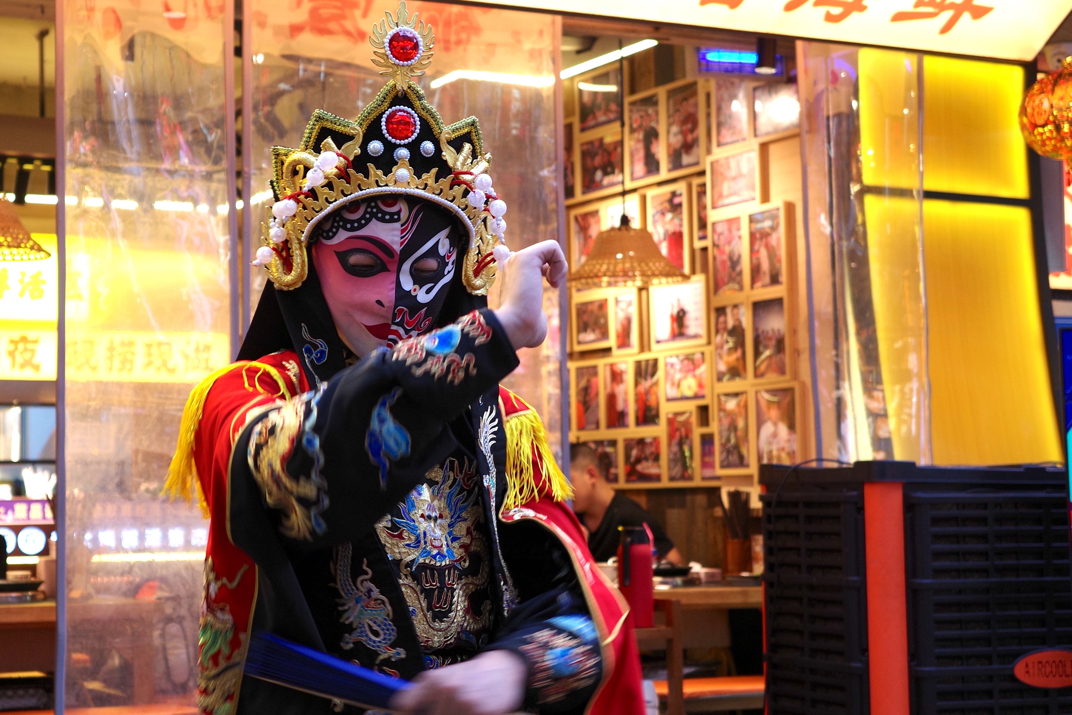 Performers deftly swipe between colourful silk masks as part of a tradition known as 'bian lian' or 'face-changing' (Venus Wong)