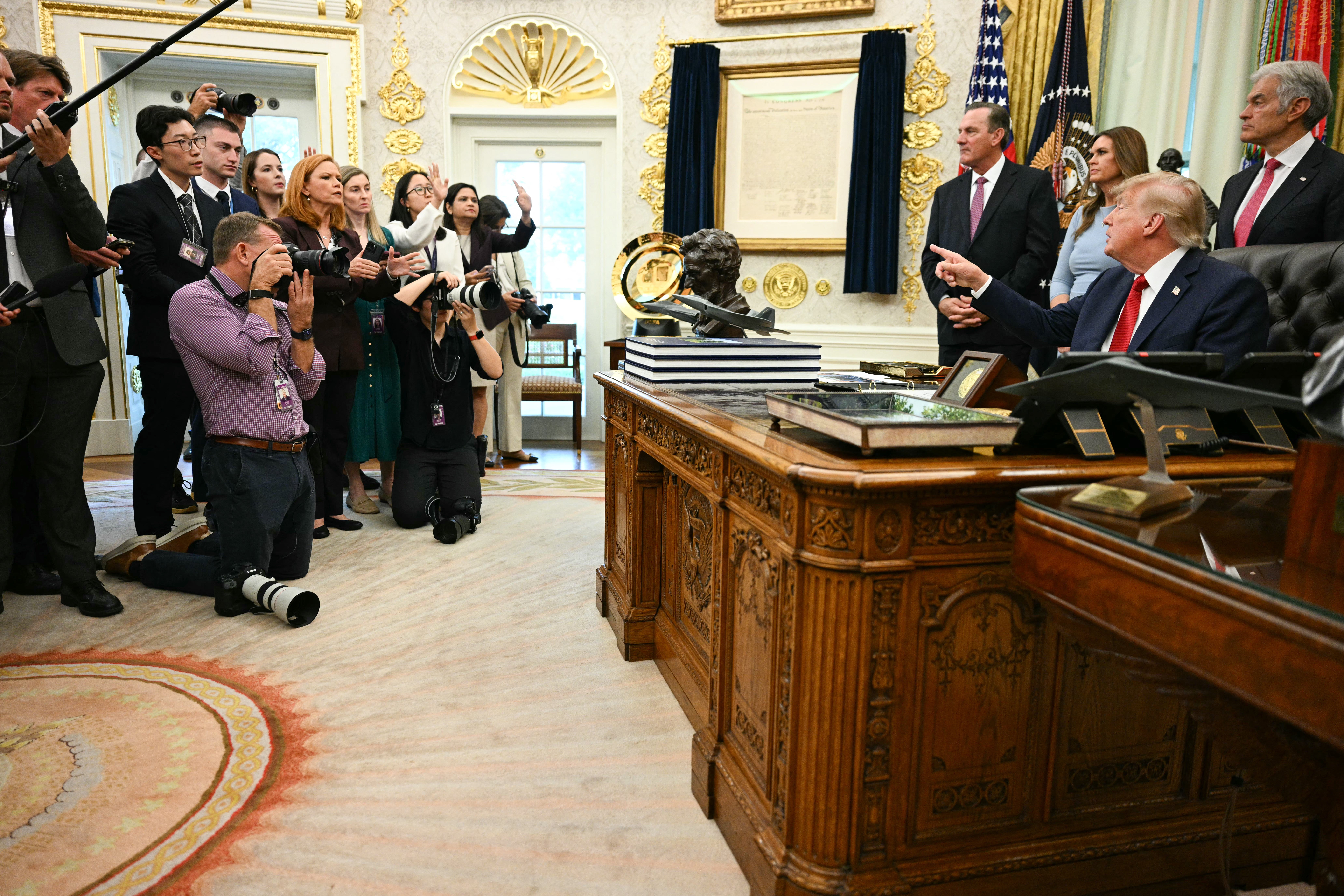 Trump talks to reporters in the Oval Office after announcing his White House ban on CNN, MS NOW and Politico