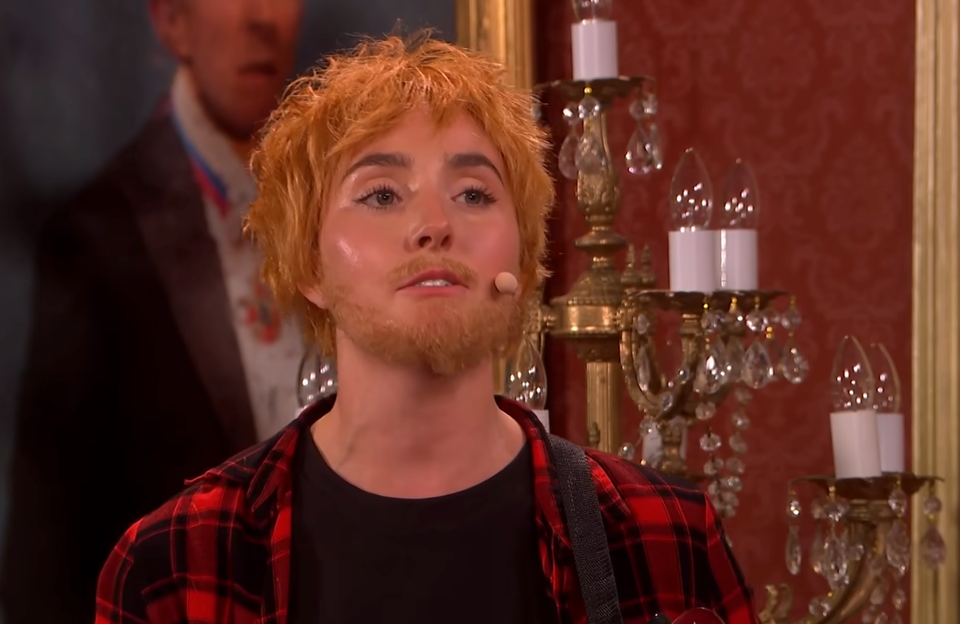 Annabel Marlow as Ed Sheeran 'sitting on the fence' on SNL UK (Sky)