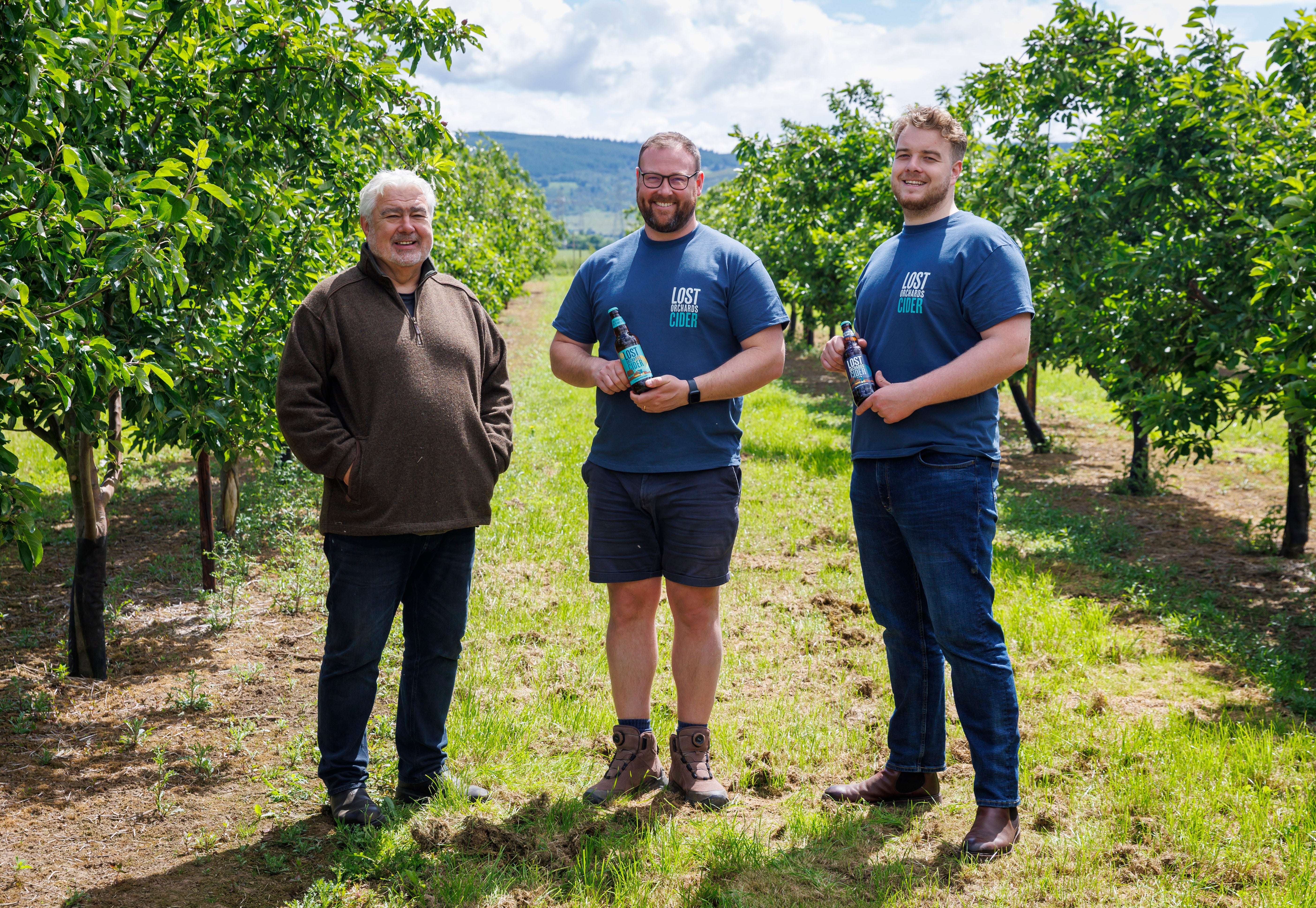 Pictured from left are, Angus Morrison, co-founder of Lost Orchards Cider, farmer Fin Hay of Hay Farms at Easter Rhynd in Perthshire and at right is Jamie Morrison also of Lost Orchards Cider. They are pictured at Hay Farms Orchard at Easter Rhynd where they are growing apples for Lost Orchards Cider (Story Shop/PA)